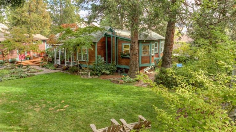 You will fall in love with this beautifully maintained home and it's park-like grounds! Located in the Skidmore Academy Historic district this home, originally built in 1895, but totally updated, is close to downtown Ashland and all the city has to offer. The main house has 2 bedrooms, 2 full baths, formal living and dining rooms, beautiful kitchen with breakfast area on the main level and huge family room, office, 2 bedroom's, bath and laundry on the lower level for a total of 2,497 sq.ft. The charming guest house, 340 Scenic Drive, of 509 sq.ft. is a legal rental and has been rented as a traveler's accommodation. Rentals are a minimum of 30 days. The secluded yard features a huge deck, pond with water feature and a chicken coop! Property has TID for landscaping irrigation.