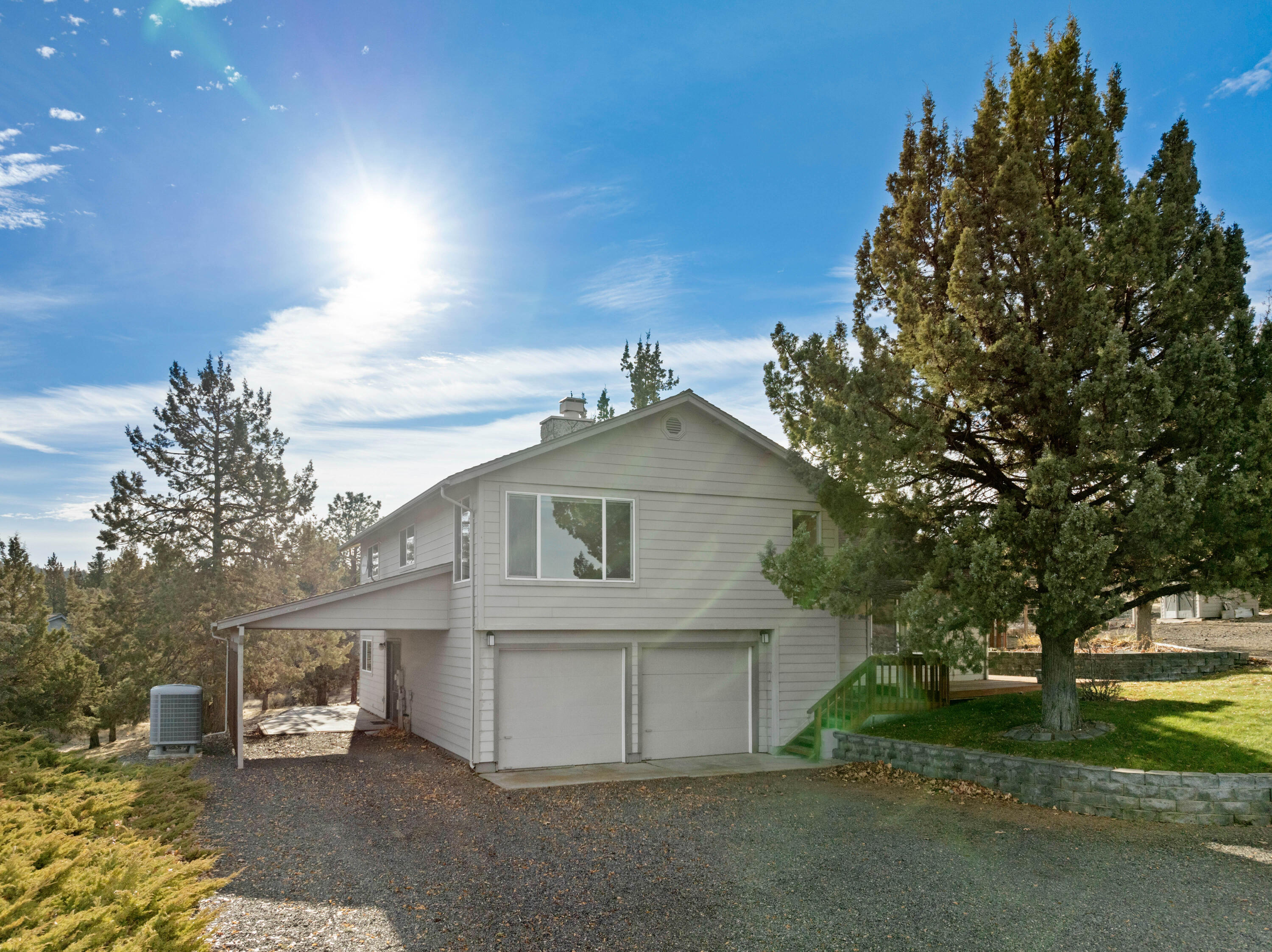Beautiful home nestled on spacious 2.14 acres with spectacular views of Smith Rock, Mt Jefferson and Mt Hood! The kitchen is a chef's delight with expansive island, updated appliances and lots of cabinets for storage. The great room boasts solid hardwood floors with a wood burning fireplace blending natural beauty with a cozy atmosphere. The upper-level features three bedrooms and a full bathroom with double vanities perfect for family or guests. The lower-level offers a large 4th bedroom with patio access, a bathroom and a generous laundry room. This property features a dedicated garden area that is fully fenced and equipped with hassle-free drip irrigation. Additonally, there are  two storage sheds and a 26x39 ft shop with a separate driveway for easy access and extra parking. Don't miss your opportunity to own this move-in ready home with acreage in desirable Cinder Butte Estates subdivision just minutes from Redmond!