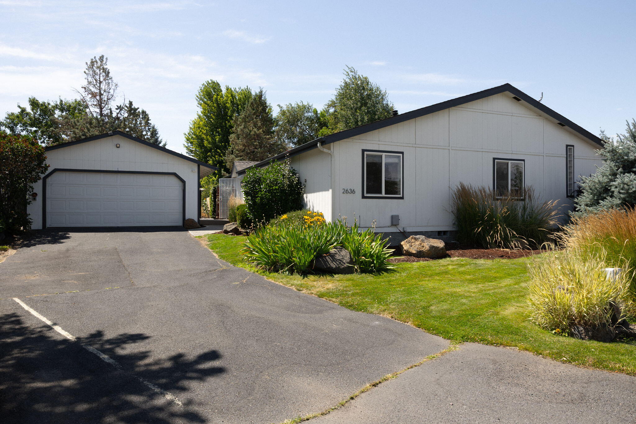 NEW ROOF, INTERIOR PAINT & CARPET.Park-like tranquility in the heart of Redmond, this beautifully maintained ranch-style home on a rare 0.4 acre lot offers serene retreat w/ mature landscaping and a 30-ft diameter pond complete w/ fountain and creek- creating a private, natural sanctuary right at your doorstep. Spanning 1,872 sqft, the home has 3 bedrooms and 2 baths. The flowing open floor plan features 13-ft vaulted ceilings, and expansive windows that grace the interiors w/ natural light while framing views of the greenery outside. Spacious kitchen w/ pantry, breakfast bar, dining area, and 2 sliders to the backyard designed for both comfort and connection. Private primary suite features a walk-in closet and ensuite bath w/ dual sinks and walk-in shower offering a quiet retreat. Soak in any season on your expansive deck with hot tub. Additional amenities include boat/trailer/wood storage in private area behind backyard, fenced in yard, shed, and EV charger.