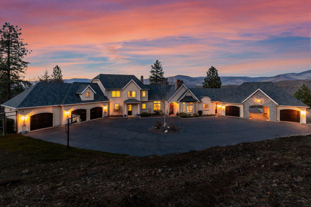 French country home with amazing views of the lake, mountains & sunsets. Close to downtown Ashland. Reclaimed wood beams, solid wood doors, trim and baseboards throughout. 20+ acres including its own small vineyard providing outstanding Tempranillo wine. Large island in the gourmet kitchen with Viking appliances. Including double convection oven, 6 burner gas cooktop, built in wine refrigerator, granite countertops, hardwood floors, and large butler pantry.  6 fireplaces and a 5-car garage. Beautiful library/office with fireplace, large windows and ceilings to take in the forever views. Large covered/uncovered patio areas with fireplace and built in BBQ, and living area. Tranquil courtyard with separate studio that has vaulted ceilings, formal living & dinning room, plus bonus room. This house has it all, approximately 6331 SQFT. This is country living at its finest and just outside of Ashland.