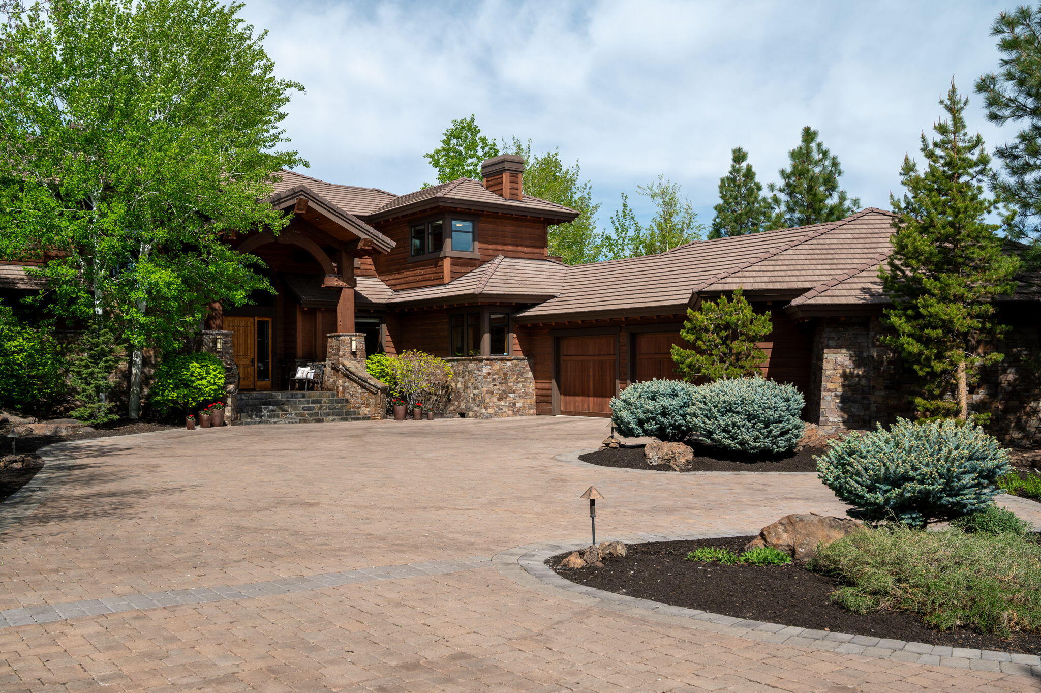 Offered for the first time, this 5,254 SF estate is located within the private gates of Juniper Preserve Resort ~ The Club at Pronghorn. Positioned on the 6th fairway of the Jack Nicklaus Signature Golf Course, the home captures stunning Cascade Mountain views and offers the ultimate in resort living. Thoughtfully designed with 4 bedrooms, 4.5 baths, and a spacious main-level primary suite, this residence blends timeless craftsmanship with modern luxury. A dramatic wood-burning fireplace anchors the great room, while the chef's kitchen, wine cellar, and seamless indoor-outdoor living make entertaining effortless. The oversized three-car garage adds flexibility. A full Premier Club Membership ($115,000 value) is included, granting access to world-class amenities. Whether a full-time residence or private retreat, this is a rare opportunity to own a legacy home in one of Central Oregon's most exclusive communities.