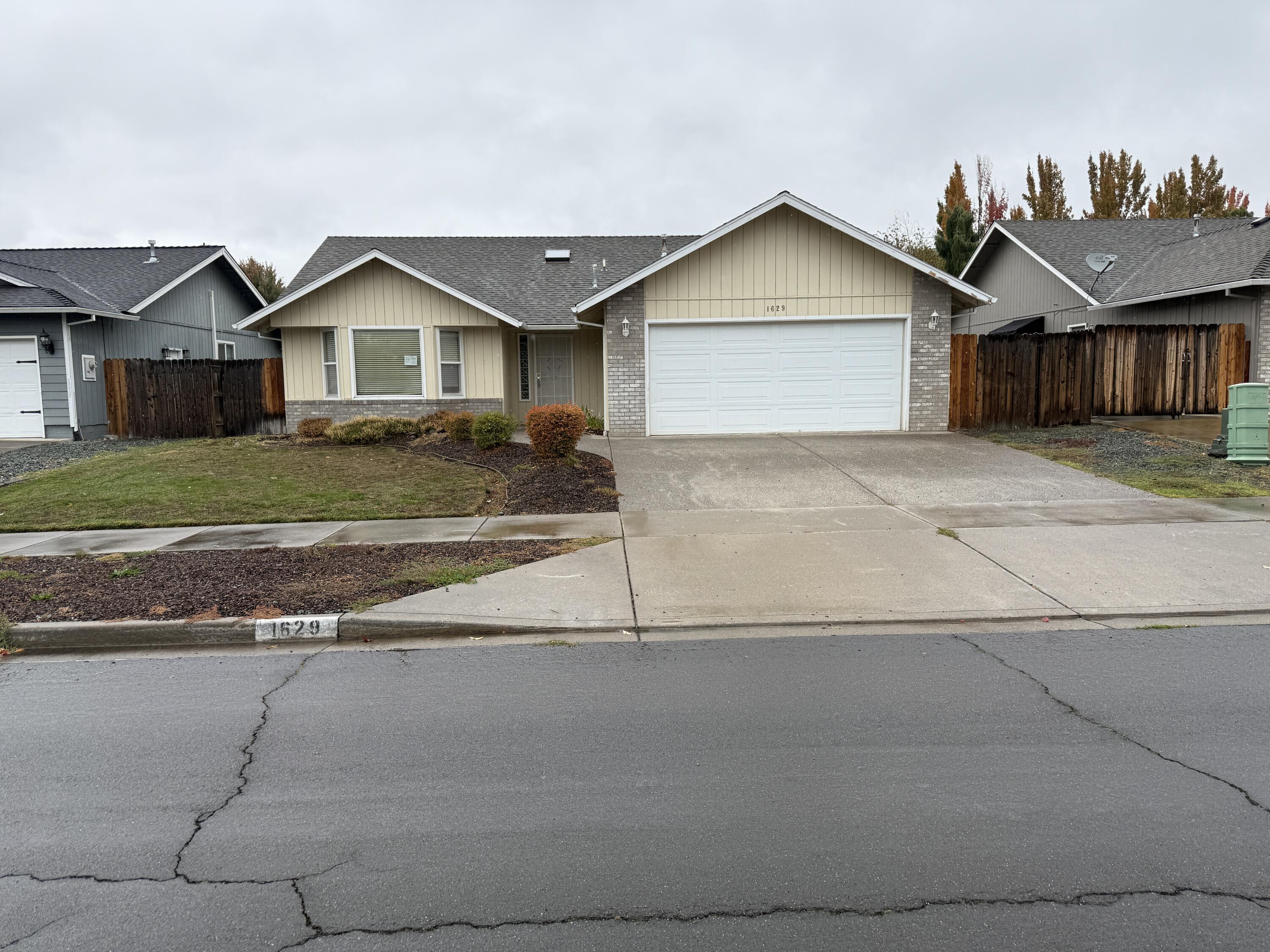 Welcome to this East Medford gem located in the desirable Hedrick Middle and North Medford High School district! This 3-bedroom, 2-bath home offers 1,507 sq. ft. of comfortable living space on a 0.15-acre lot with small trailer parking.  The main living areas flow naturally, creating an inviting space for both relaxation and gathering. The primary suite features a private bath and walk-in closet, and the home includes a convenient 2-car garage. Outside, you'll find a concrete patio and landscaping that's a blank slate—ready for your green thumb and personal touch. Ideally situated just minutes from shopping, dining, and local amenities, this home is simply awaiting its new owner to make it their own.