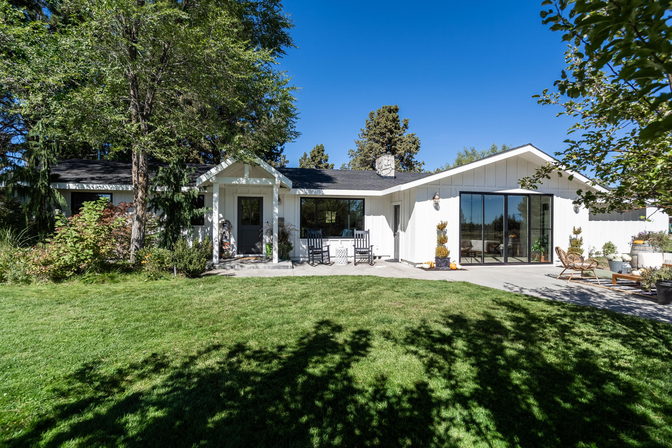 Fully remodeled haven located just north of Pine Nursery, this modern farmhouse dream is tucked away, providing the ultimate privacy minutes from town. Sitting among mature pines, the open concept single level features a great room with dual sided FP and master suite with oversized walk in closet. The light-filled bonus room with brand new windows brings the outside in, with a fireplace to keep it cozy.  The property is fully fenced and irrigated, and features multiple outbuildings; 2 sheds, a 300 sq ft  cottage with  cellar, a 28x14 Victorian inspired glass greenhouse, and an amazing, bright 1040 sq. ft. shop/studio with pellet stove and large walk in cooler. This property provides something for everyone. Aspiring backyard gardeners will love the raised beds for fresh produce, room for a few new farm friends (miniature donkey or baby ducks, anyone?). Privacy, charm, shop space, and a designer's dream home only a stone's throw from parks, trails, restaurants, and shops!