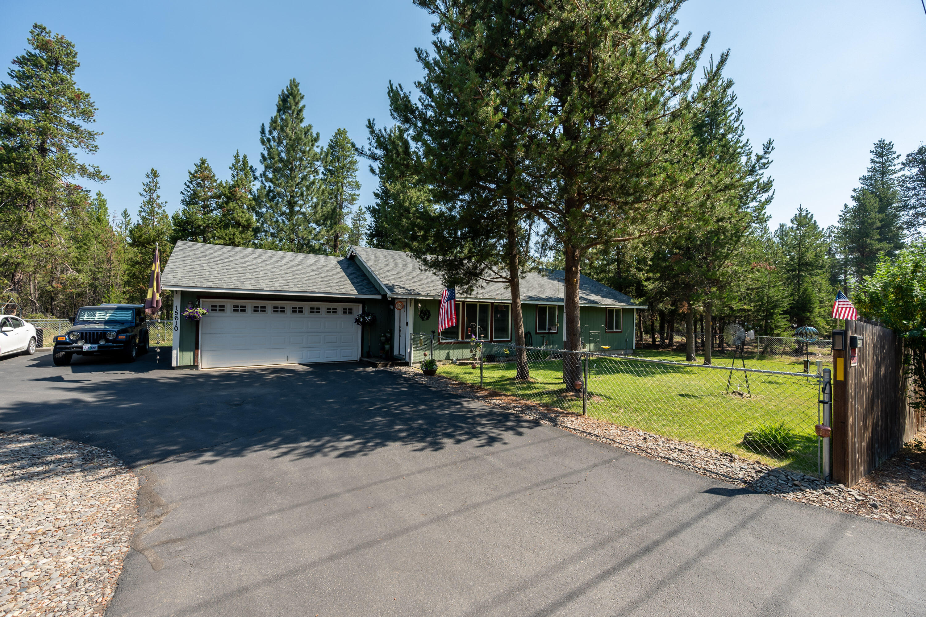 Nicely maintained single level home with a 3 head ductless heating system allowing for efficient cooling and heating all year round. The house has a great room layout and vaulted ceilings. The primary bedroom is large enough for a king bed and has a very generous bathroom. Both guest bedrooms are very functional with room for queen beds and share a guest bath that has a tub shower combo. Attached is a double garage that is fully insulated, has built in storage, and a man door with access to the extra parking area. The yard is fully fenced and there are separate front and back yards. The RV parking area will fit larger RV's and there's an additional carport for your vehicles or toys. Location is key and this home is close to everything and located right on a paved road. Utilities are very affordable with the home having a well and septic system, meaning your only bills are power and TV/internet.