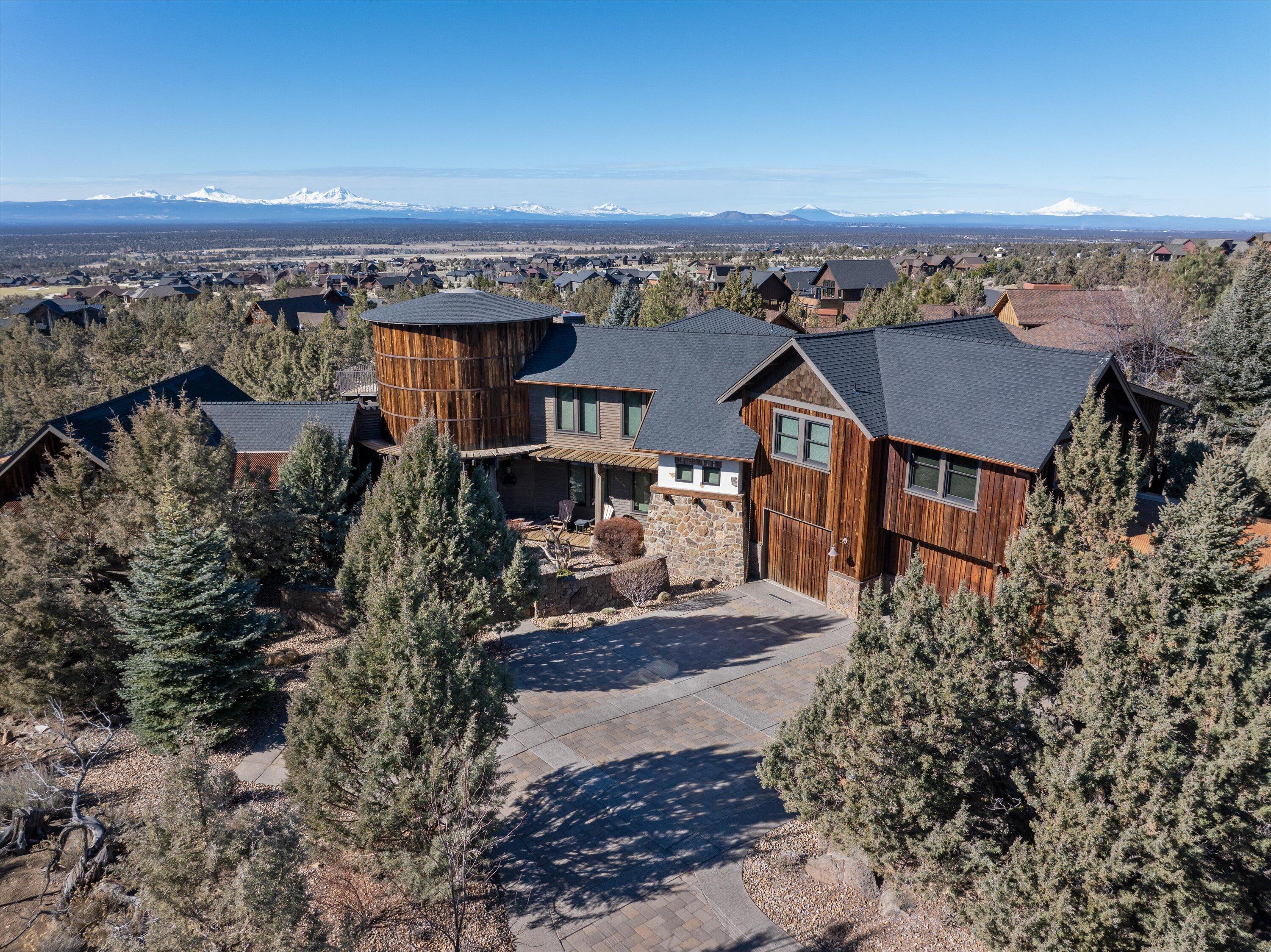 Iconic Custom Home w/ breathtaking panoramic Cascade Mtn views. Gorgeous natural landscaping surrounds this home to offer solitude and tranquility. Distinctive craftsmanship & quality of materials abound as you enter. In the open floorplan you will find, a vaulted great room w/ expansive stone fireplace, dining area, & prestigious kitchen boasting of counter space, stainless appliances, and a butler pantry. The spacious primary bedroom offers vaulted ceilings, rich beam work & a warm fireplace. The primary bath offers a well-situated soaking tub & large shower w/ dual vanities. An additional bdrm w/ deck access & a spacious laundry room complete the main floor. Upstairs, you will find another bdrm, full bath, family room w/ kitchen, an office, & an upper deck to enjoy the stunning Brasada sunsets. Downstairs is an impressive wine cellar, family room, a bdrm w/ full bath and access to outdoors. Outside, you will find an outdoor kitchen area complete with barbeque and stone fireplace.