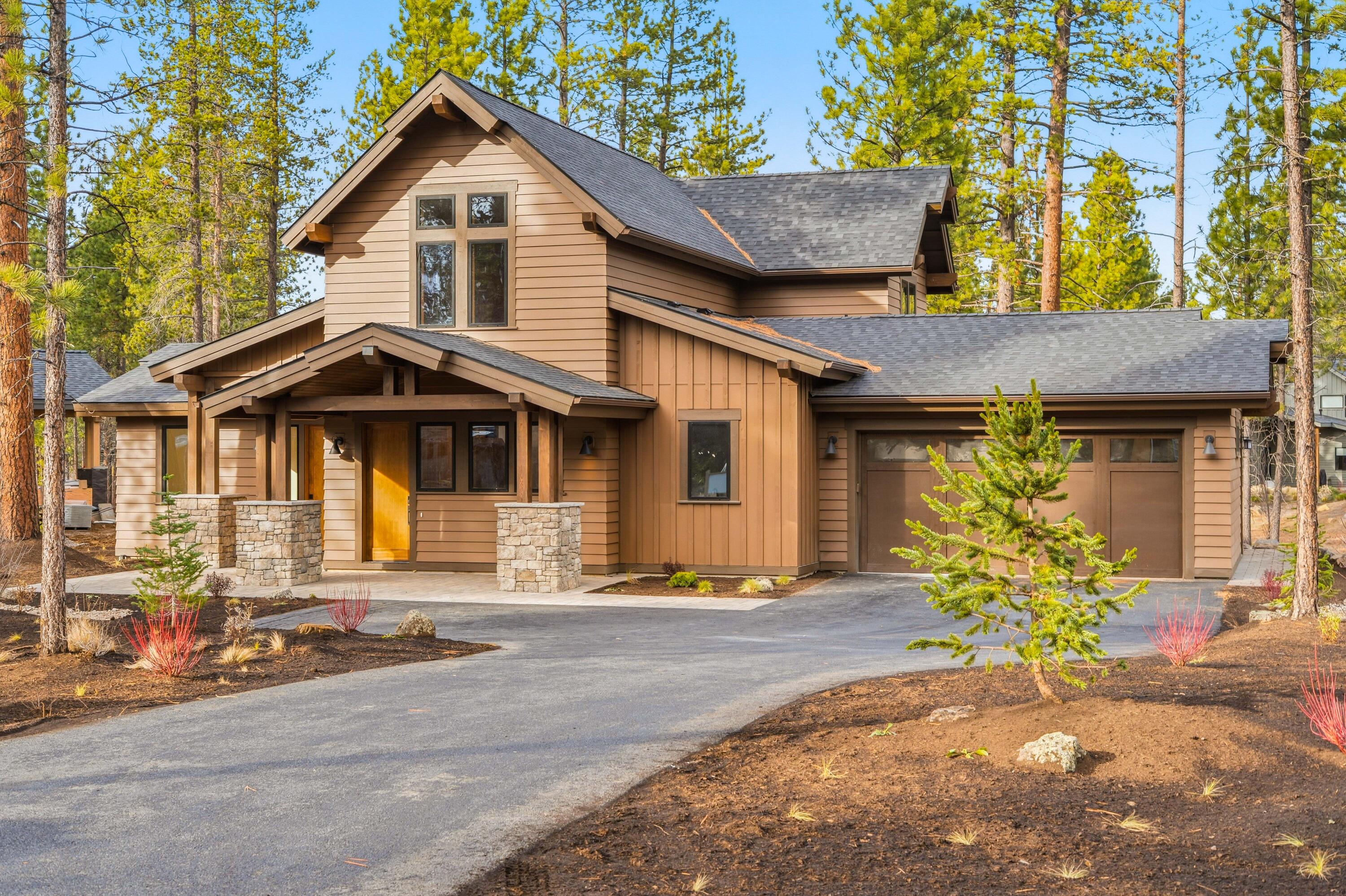 Introducing a beautifully crafted home by Curtis Homes LLC, where luxury meets mountain living in the heart of Caldera Springs. Discover a thoughtful layout that blends functionality and elegance, redefining the way you live or vacation. Two primary suites on the main, separated by the open concept living area plus an additional en-suite with that can be locked off. The additional main level suite has its own separate entrance & private covered porch—ideal for additional guests, multigenerational living, or a private home office setup. Upstairs features a bedroom, custom bunkroom, bonus room & full bath. Indoor-outdoor living is a hallmark of this home, with sliding glass doors that open to an elevated Trex balcony overlooking the stream-spanning the entire back, enjoy covered and uncovered areas with a recessed hot tub. The spacious 2-car garage offers ample storage for all essentials. Just steps from the new Forest House-where relaxation meets adventure-enjoy resort living everyday!