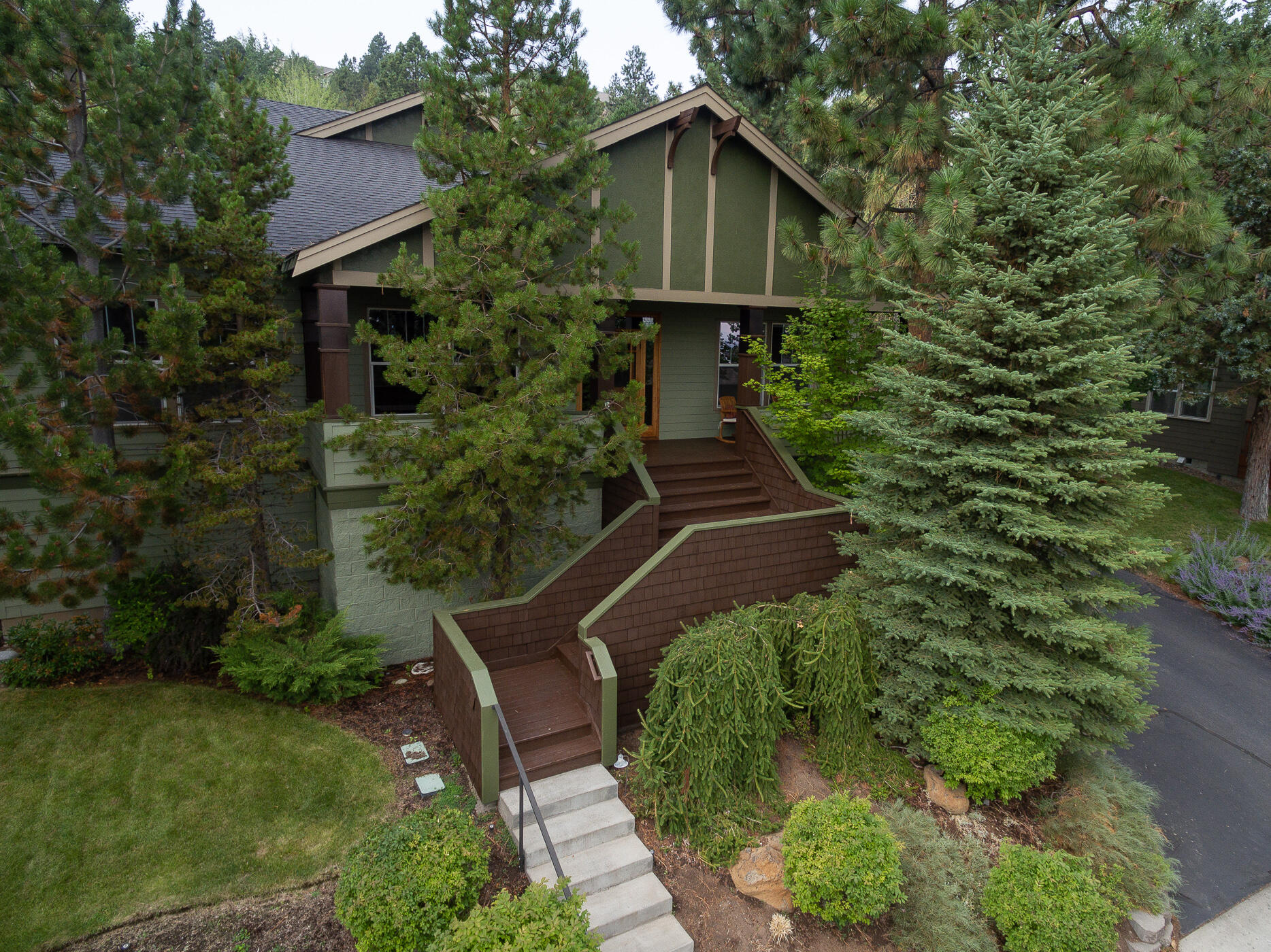 This updated Awbrey Village classic is a wonderful option in one of Bend's coveted west side neighborhoods. Set within the trees for extra privacy, the great room vaulted ceilings bring in extra light and spaciousness. The gorgeous main floor primary suite is updated with new carpet, double vanity and glass walk-in shower.  Another main floor en suite is a great option for guests who don't care for stairs. Upstairs is a large bonus room and 2 additional bedrooms. The 3-car garage allows room for extra toys! New exterior paint, A/C, refurbished deck, recirculating hot water heater, Nest thermostat, bathroom remodels.