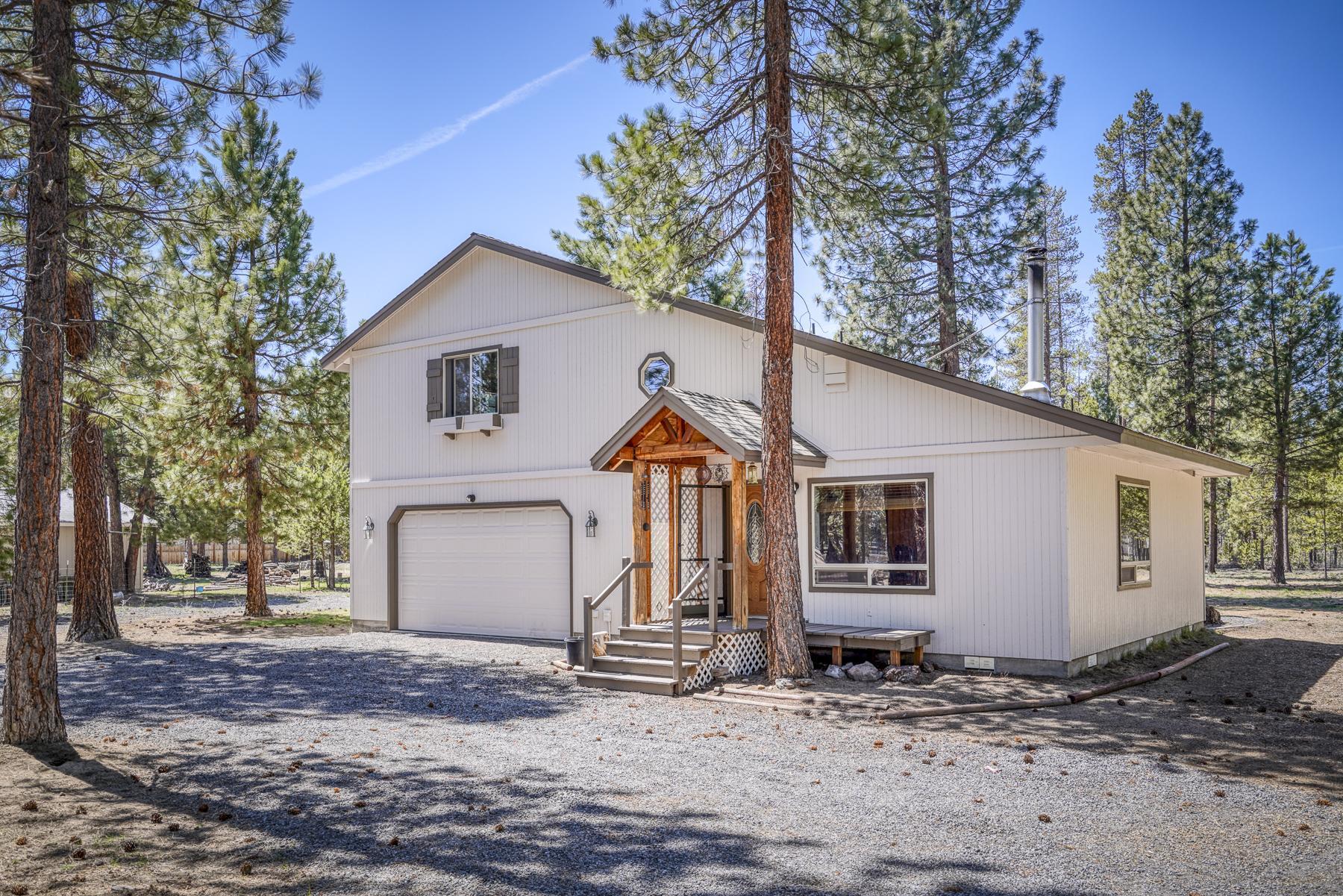 Bring all offers! Seller is ready to move. Lodge style, 2 bedrooms, 1.5 bath, 1,344 square foot stick-built home on .99 acres completely fenced and gated.  The home has been newly painted, and decks stained. Turn key! Rural zoning allows for horses. Both bedrooms are large enough to fit king size beds.  Kitchen has granite countertops and alder wood cabinets. Great room design with an elevated wood stove. The garage is 24 x 28 heated and insulated. Circular driveway in front and located on a cull de sac. The way the home is positioned allows for entrance to the back from either side of the home. Perfect home for a contractor who needs room for equipment.  RV Hookup, Small Shop and Storage Unit.  Washer, Dryer, Refrigerators in Garage, and home included plus the snow blower.  Hot water heater is Light duty Commercial 80 gallon.