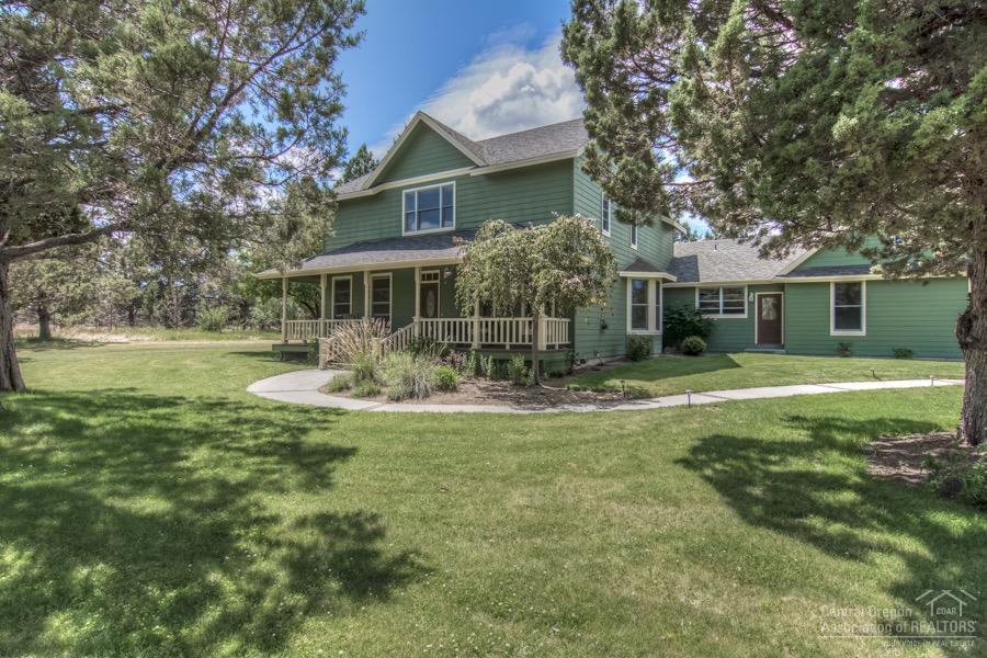 Check out 3-D virtual tour. Immaculate & secluded farmhouse surround by green fields & trees. Come sit out on your covered porch while admiring your private estate. Minutes from the amenities of Bend this home has all the boxes checked. Updated kitchen, breakfast bar & french doors out to back deck. Cozy/stately den w/wood beams & wood wall details. Bonus rm w/wood flooring. Formal living & dining for special occasions. Lg Mstr suite w/ his & her walk in closets, updated bthrms & storage/loft above garage.