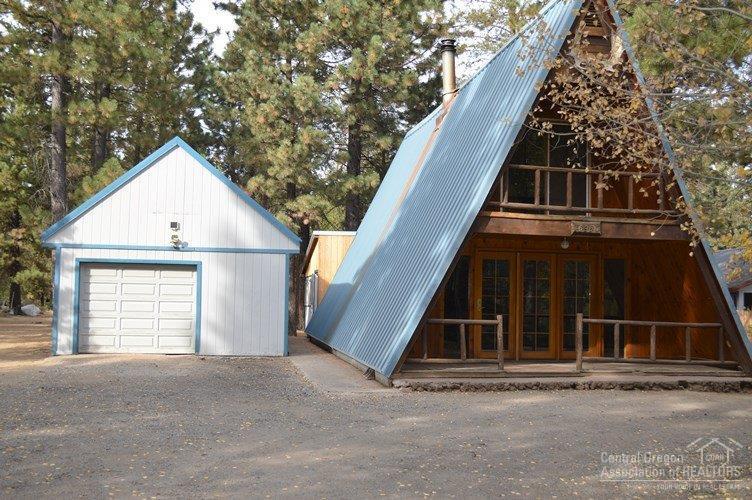 This charming chalet in Three Rivers is on a 3/4 acre lot and is ready for a new owner. This A-frame home has been lovingly lived in by the same owner for many years. Wood accents throughout with pitched metal roof. Keep warm with the wood burning stove that help heats the entire home. Upstairs are two bedrooms and 1/2 bath. Main living area has kitchen with stove and refrigerator, laundry room with washer & dryer, a full bath and a great room. The bonus room is built on the back of the original home.