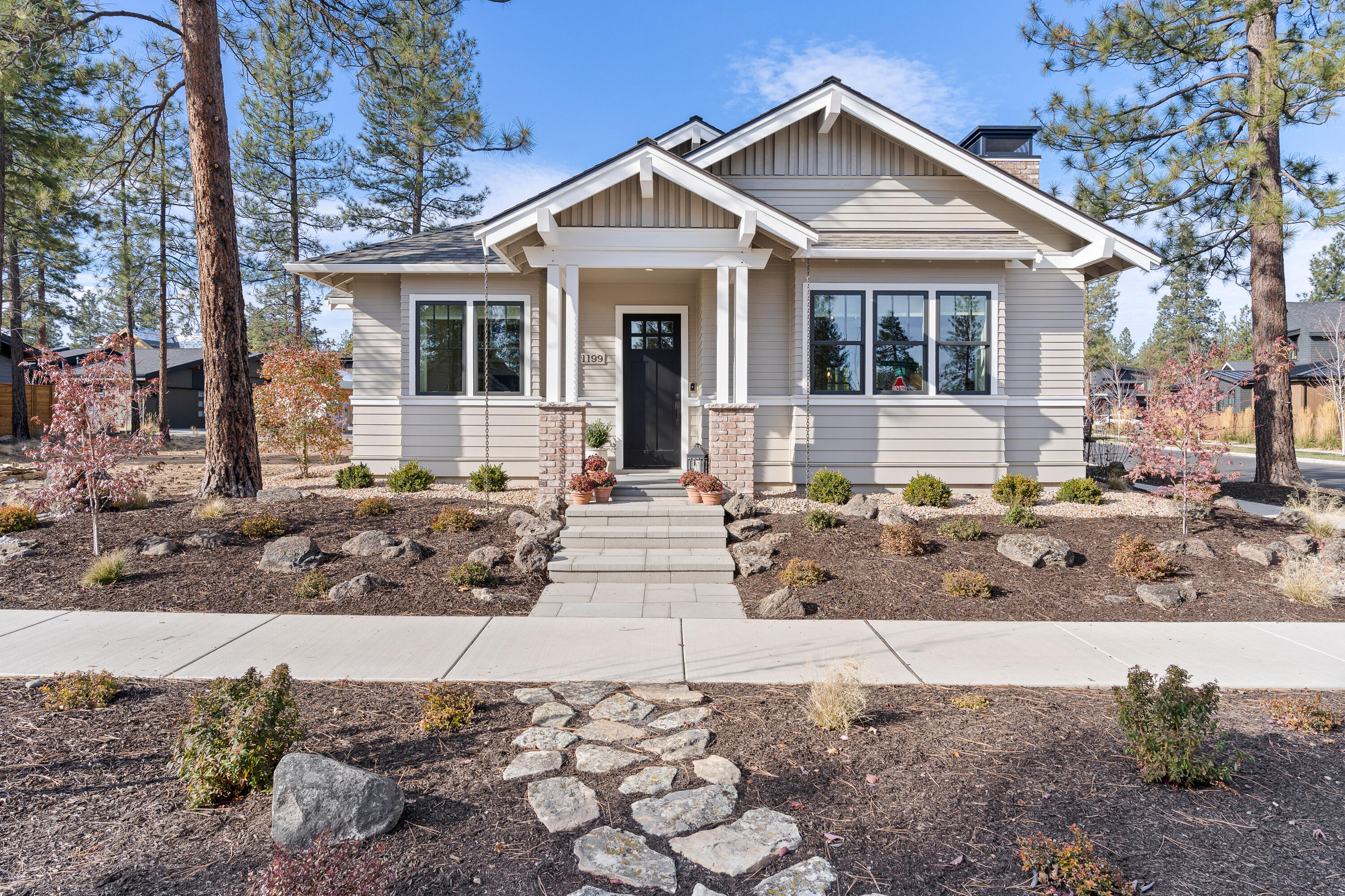 Welcome to the perfect blend of modern convenience and respite from the hustle and bustle of city living. Situated in the Discovery West community, this beautifully crafted home by Salvesen Homes, offers just the right amount of understated elegance. Positioned on a corner lot with views of the tranquil greenbelt, it is sure to captivate with its style and charm.  This single-level home offers designer extra wide plank flooring, shiplap, and special touches like Hammerton Lighting and Ann Sacks Tile. With its open kitchen, Wolf range and plentiful storage, this home is a Cook's delight. Whether entertaining friends and family, or snuggling up in front of the cozy fireplace, this home checks all of the boxes.   With two good sized bedrooms, plus a den/office with custom built in cabinets, this plan offers great flexibility.  Enjoy the great outdoors on the paver patio surrounded by granite boulders and a low-maintenance garden. Downsize without giving up quality, this home has it all.