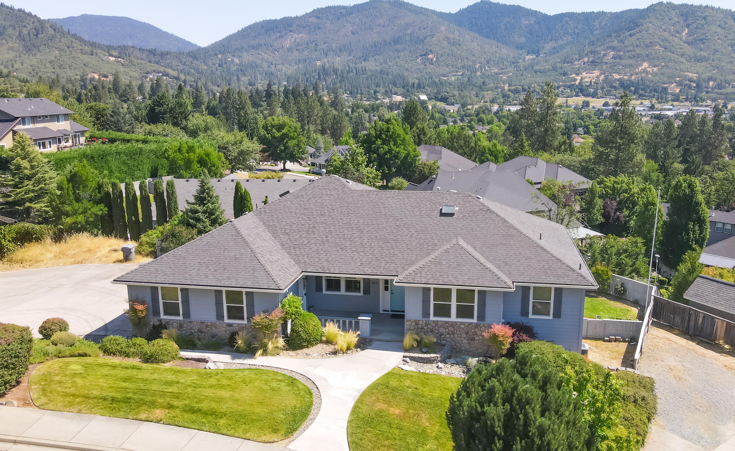 Beautiful updated home with 9' ceilings in the highly desirable northwest side of Grants Pass with stunning city & mountain views! The gourmet island / breakfast-bar kitchen with huge walk-in pantry has been fully updated with new granite counters, subway tile backsplash, undermount sink, stainless appliances & white painted cabinets. Dine at the bar or the formal dining room. The living room features a gas fireplace & huge picture windows for enjoying the panoramic views. Beautiful, all-new engineered hardwood floors throughout the main floor. Roomy primary bedroom features those panoramic views, spacious walk-in closet & updated bath with gorgeous tile shower & heated tile floors. Bedroom 2 & updated hall bath with skylight are also on the main floor. Downstairs you'll find a family room with updated floors, bedroom 3 & another updated bath with beautiful marble countertop & tile shower plus a craft room & basement storage. Near instant hot water too! Call for a look inside today!