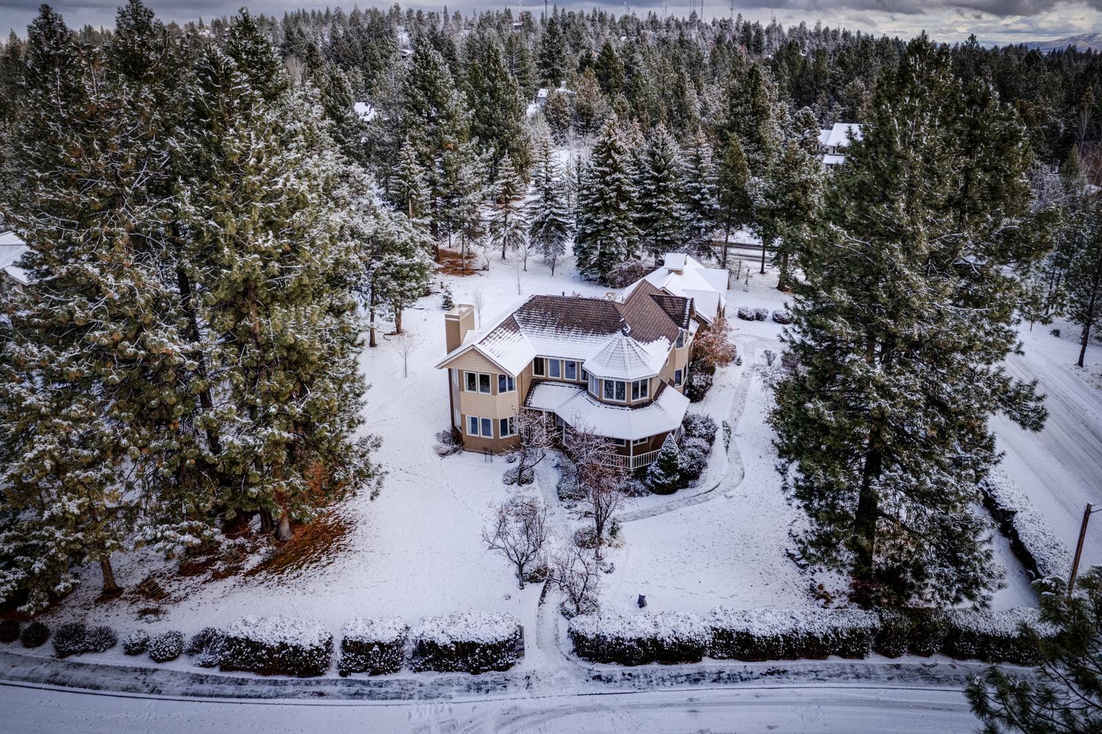 This home exudes story book charm with its gingerbread trim and Victorian style architecture and graces a prominent spot at the top of Awbrey Butte. The traditional floor plan is comfortably laid out and provides ample separation for in-home office yet open between the kitchen and family room. This home is a solid build with warm woodwork, bay windows, woodstove fireplace, is bright & light with many more custom features. It's spacious flat lot with beautiful flowering and evergreen trees has plenty of open space for game and sporting activities! A flat paver driveway with large 3 car garage is super convenient. This is a unique and charming home ready for your custom updating.