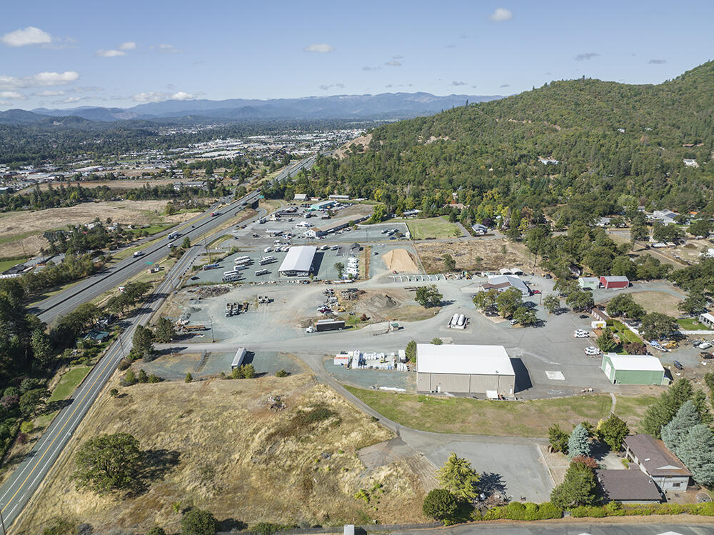 For Sale or Lease! 3.57 Acres of Prime Rural Commercial Property with Impressive On-Site Development, Fantastic I-5 Exposure & Easy Access in the Town of Grants Pass, Oregon! This Well-Kept Property contains 3 Main Buildings, including an Incredible 11,502 Sq Ft Clear-Span Commercial Shop w/Offices, Storage, a 40'X20' Main Door & Large Roll-up Side Door; 2,766 Sq Ft Shop/Office Building w/Restroom & Mezzanine; & a 4,344 Sq Ft Executive Office Building/Residence prepped for Commercial Kitchen. Rural Industrial Zoning allows for a multitude of Industrial/Commercial uses, & allows for Property Division into 1/2 Acre Parcels! Minutes to City Limits & I-5 Ramps, & enjoys a Low County Tax Rate. Massive Asphalted Parking Space. Excellent Visibility & Signage. Ready to go for your Next Commercial Venture! The Adjoining 3.11 Acre Industrial Parcel is available also, with Separate Power Drop, Meter, & Other Utilities. There is Amazing Opportunity here!