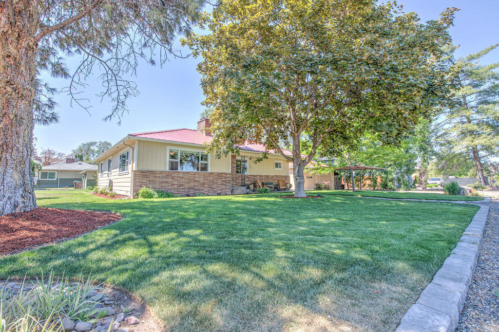 Have you been waiting for a single story with charm and character?  If so this home has it all!  Built-ins, original shiplap behind almost every wall, built in desk with shelving waiting for your books and decor.  3 bed 2 bath lives larger than its 1473 sqft.  Meticulously maintained and boasts many upgrades throughout. Enter to the inviting living room with accent shiplap wall and brick surround gas fireplace.  New laminate flooring throughout.  Updated counters in kitchen and original mid century modern cabinets that are all the rage. Main bathroom has been enlarged. Mud room for laundry and storage. Beautiful landscaping with paver walkway to give a nice pleasant curb appeal.  This cozy house is move in ready, and would make a lovely home to settle in the heart of Prineville.