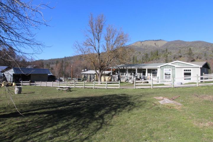 Historic Yale Creek Ranch located on the confluence of Little Applegate River & Yale Creek. 80+ acres of easy sloping irrig. pasture w/ some of the oldest water rights in the valley. State of the Art undeground irrig. system all in place w/ gravity fed pasture from the upper ditch. Plenty of room for cattle, horses & farm to you hearts content. Fenced & x-fenced w/ dairy cows, sheep, goats and ducks roaming the pastures. Abundant room for organic gardening on the lower level fields. Two renovated historic barns, one is the hay barn the other is used for feeding cattle. Main house is a 2005 higher end manufactured home w/ 3 bds, 2 bths & split floor plan. Cute 1 bd, 1 bth guest house w/ lots of windows to view the pastures and mountains in the distance. Grid tied solar system keeps the electric bill down. Greenhouse used for the ducks but can go back to gardening. Sauna house near the creek & other outbuildings including a cheese making building. Farm equipment included.