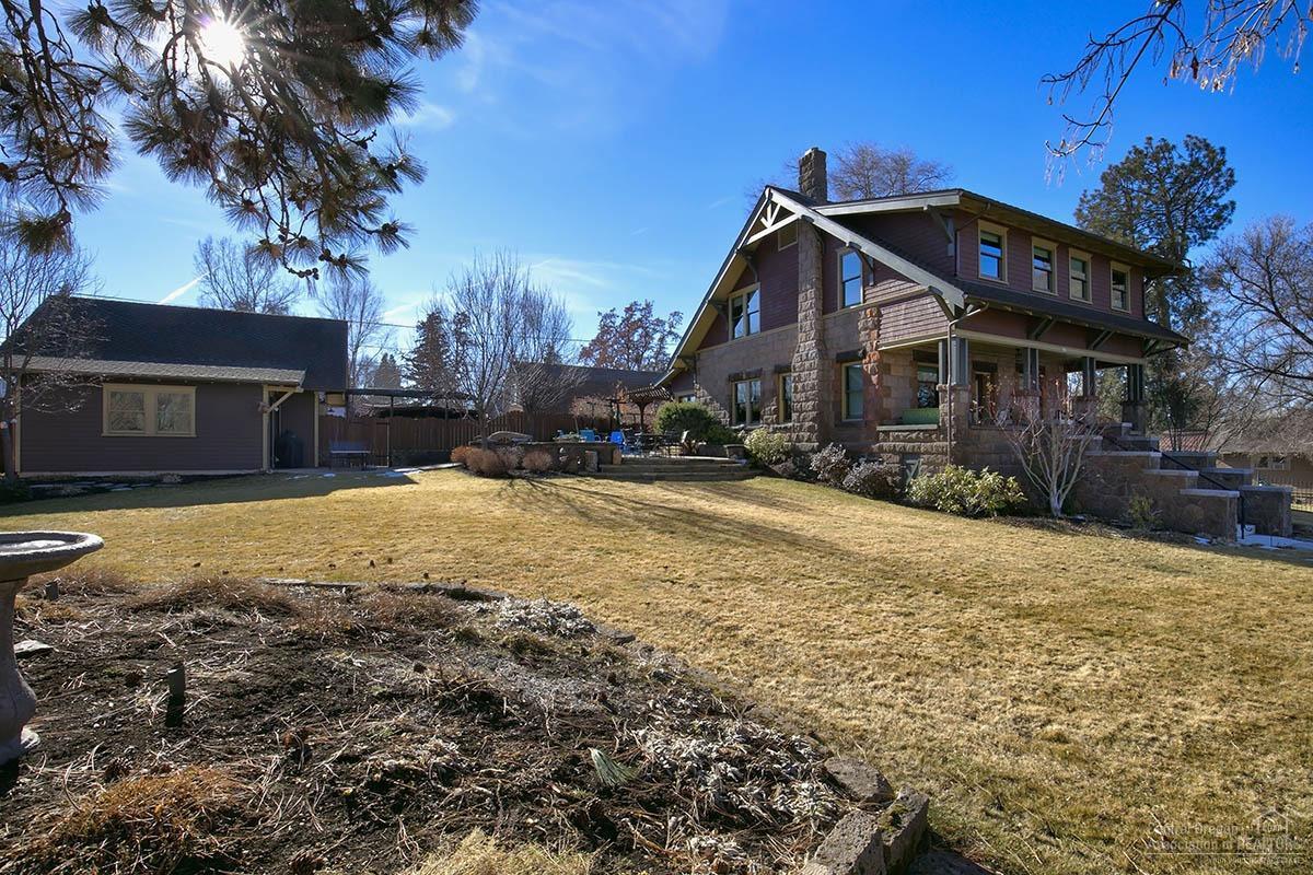The Georgia House - This Bend Icon was built in 1913 by A. L. French, a local business owner. This timeless home is perched on a 1/3 acre lot with an eagles nest view of Downtown Bend. The custom renovation of this masterpiece was completed in 2013 by Copperline Homes and is featured in the November 2015 issue of American Bungalow Magazine. The historic main house has just under 2500 sqft of living space and is highlighted by its fir wood accents and cozy warm vibe. The 336 sqft rustic ''carriage house'' with kitchenette is a perfect place for the many out of town visitors you are sure to welcome. The immaculate private patio and mature landscaping make the exterior just as inviting as inside. The recently built oversized two car garage with alley access is completely finished with 2nd level storage. Only a 5-minute walk to Downtown Bend and the Old Mill District!