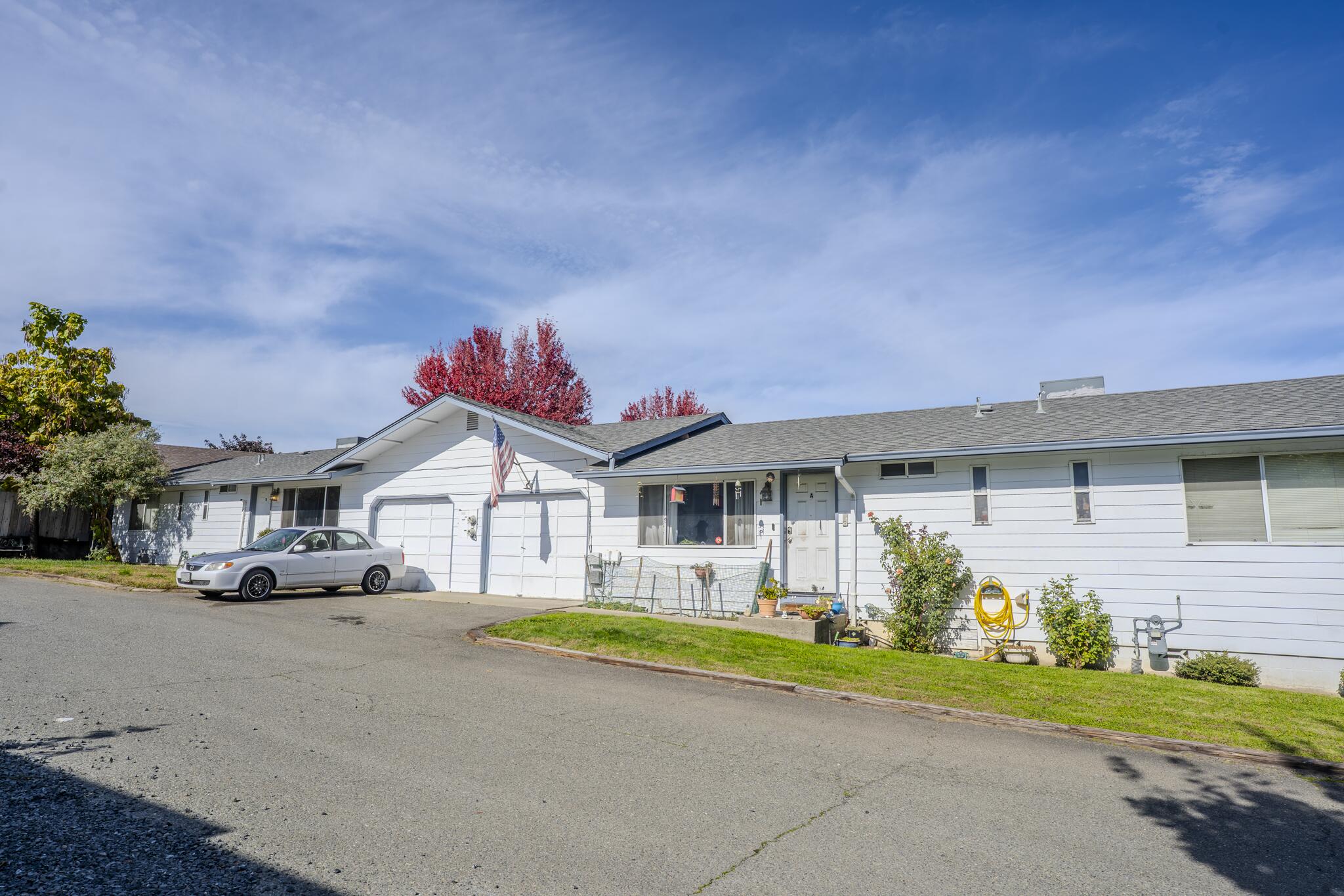 Charming Duplex Near Downtown Grants Pass! Excellent investment opportunity just minutes from the heart of town. This well-maintained duplex offers strong rental history, with both tenants having long-term occupancy and reliable monthly income. Each side features 3 bedrooms, 2 bathrooms, and its own garage—ideal for stable, long-term tenants. Both units have newer roofs and HVAC systems, providing peace of mind for years to come. Interiors could benefit from cosmetic updates, offering room for future value-add improvements. Conveniently located near shopping, dining, schools, and all city amenities, this property delivers consistent performance in a high-demand rental area. With separate utilities, ample parking, and easy-care grounds, this is a turnkey investment that combines dependable cash flow with strong upside potential in the thriving Grants Pass market.
