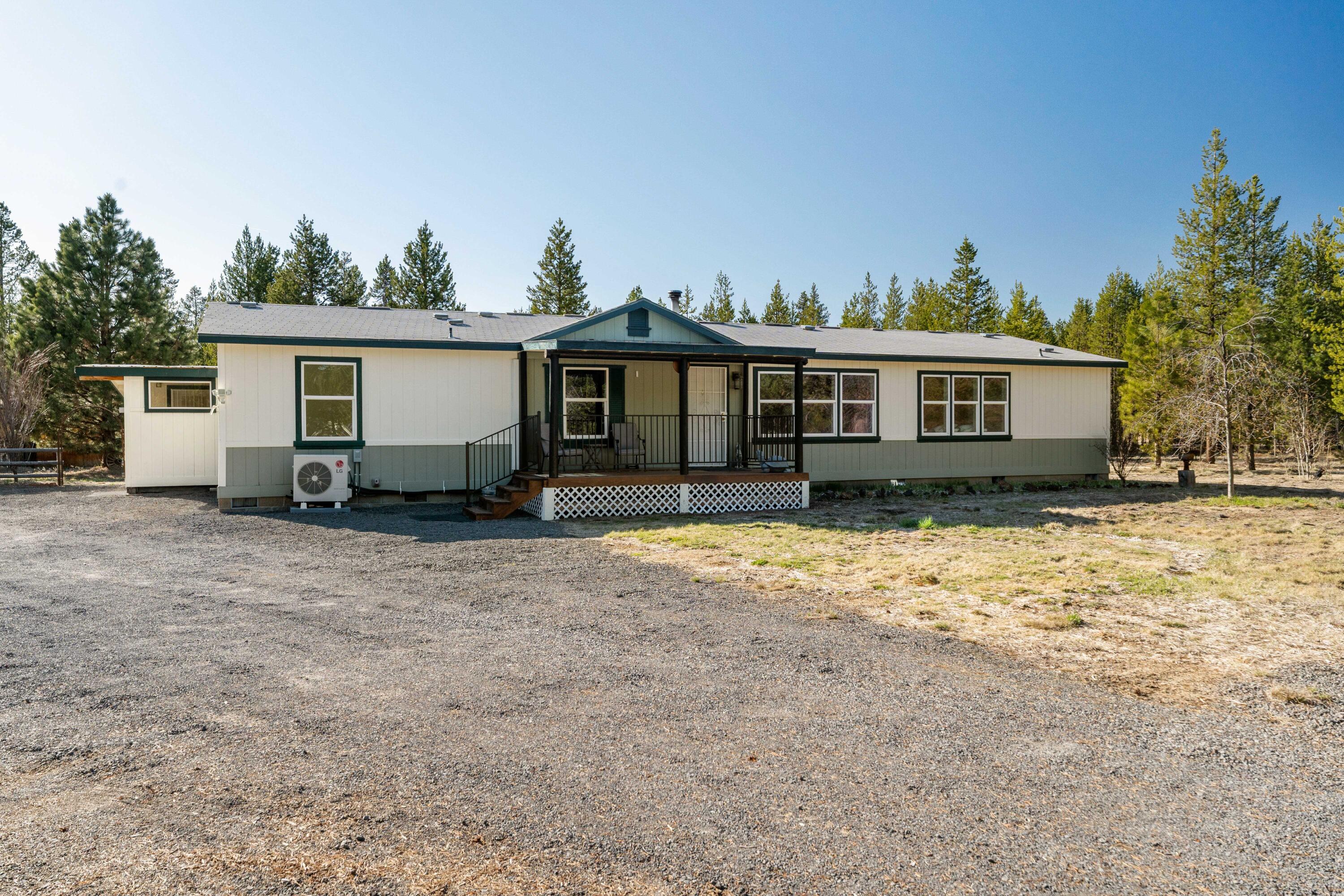 **OFFERING $10,000 IN SELLER CREDITS TOWARDS CLOSING COSTS!** Your next adventure awaits in Sun Forest Estates! With fresh paint inside and out, this beautifully maintained property offers the perfect blend of comfort and serenity set on a spacious 2-acre lot that backs up to thousands of acres of public land. The home features an inviting floor plan with abundant natural light, a cozy living area, and a well-appointed kitchen. The primary suite provides large windows and a walk-thru closet set between his & hers FULL bathrooms. The 14 x 72 sunroom is insulated and climate controlled with wood burning stove and a mini-split. Additional amenities include a 30 X 40 x 14 RV cover, a separate 26 X 30 wood frame structure with a 10 X 12 room, and a fenced and gated perimeter. The grounds are perfect for gardening, outdoor activities, or simply relaxing under the stars. Conveniently located near local amenities and outdoor recreation, this property is a true gem.