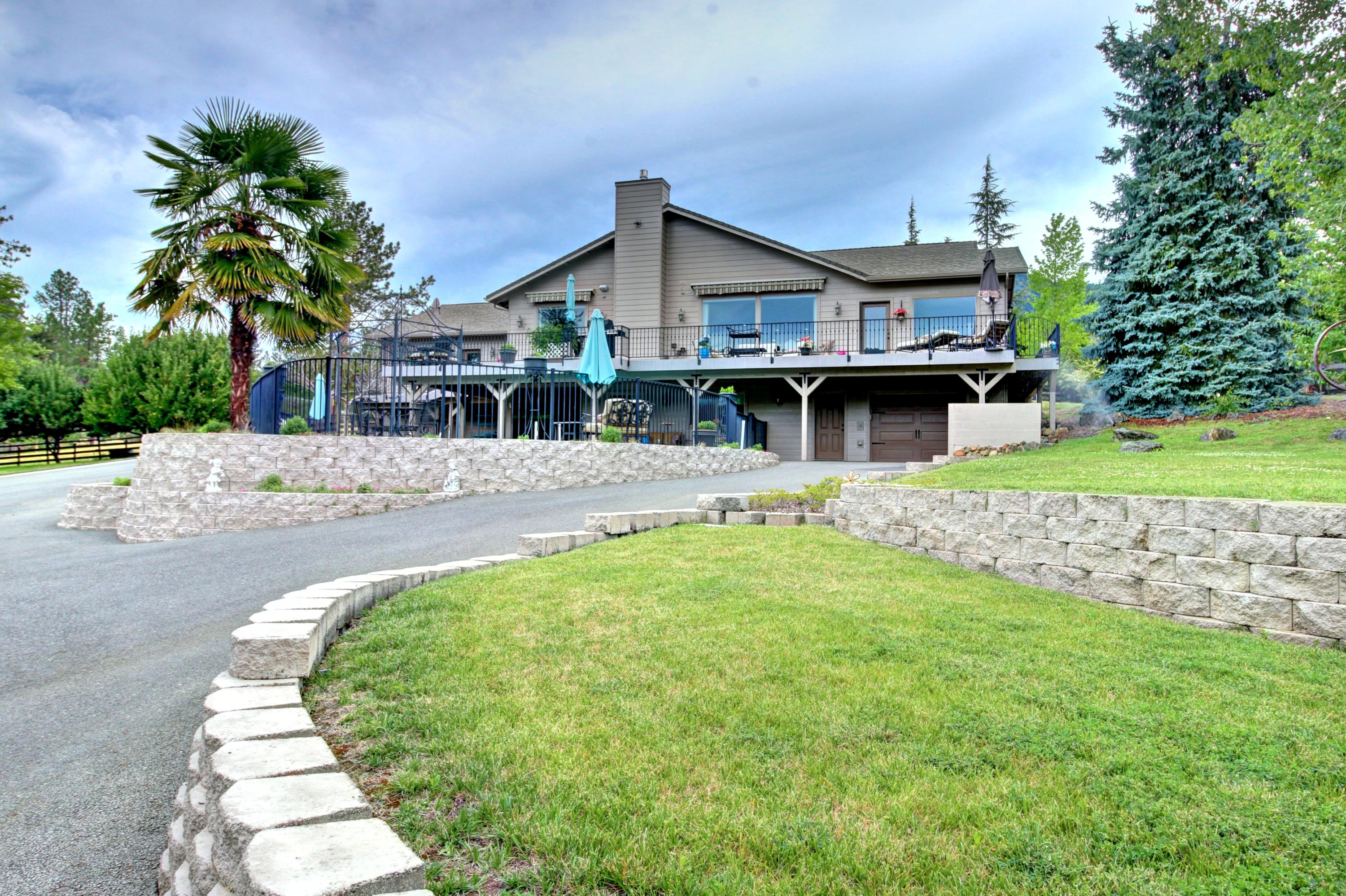 Welcome to Paradise! Well situated on over 5 acres sits this one of a kind family home. The main living area has 3 large bedrooms, 4 bathrooms, Chef's dream kitchen, large laundry facility, office and massive great room with expansive views. The kitchen has dual built in Jenn-Air refrigerators, custom cabinets,  double oven, huge island with Jenn-Air gas cook-top, walk-in pantry, all with granite counters. There is an additional wheel-chair accessible cooking area with all the amenities. The massive great room has gas fireplace, and huge expansive windows with amazing views. The main level deck overlooks the in ground pool, pond and horse pastures.  The huge finished basement features it's own living area, large bedroom, kitchen, large bathroom, laundry facilities, and direct access to the large patio and in ground pool. The property is fenced, has automatic security gate, irrigation pond, large barn with stalls, and a gorgeous horse pasture. WAY too much too list. Don't miss this one!