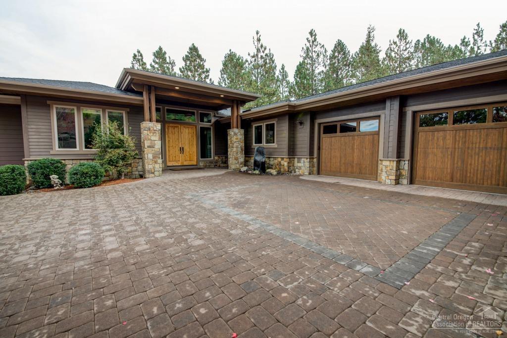 Spectacular Home on Awbrey Glens 12th Fairway. Gorgeous finishes. Walnut flooring, cherry cabinets, granite & concrete counter tops. Beautiful travertine, slate, stone and tile work throughout. Master on main floor. 4th bedroom built out office. Large gourmet kitchen. Perfect for entertaining. Large deck overlooking 12th hole. Media room with massive HD projection TV, surround sound, pool table, Wet bar and full bath. Upper and lower garages with heated driveway. Very private setting on cul de sac.
