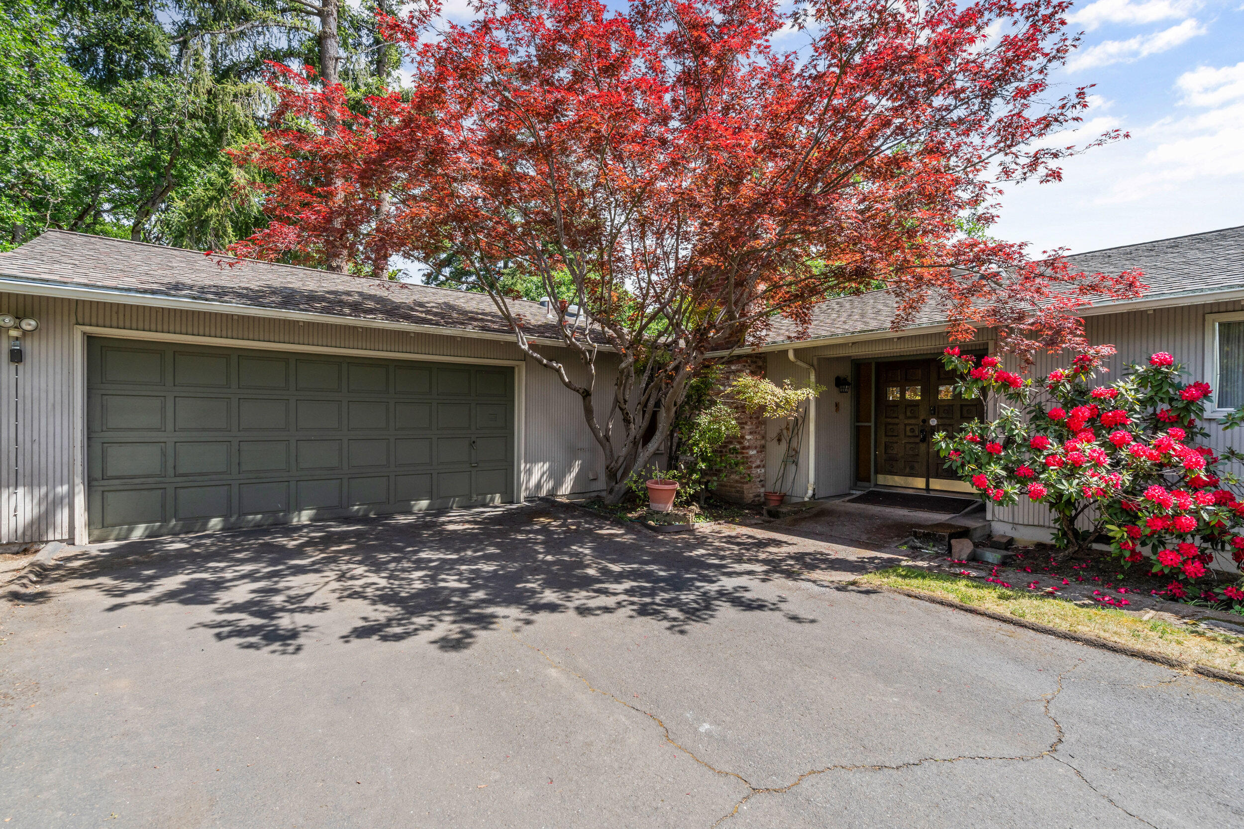 On one of Old East Medford's most coveted streets, this 4BR/2.5BA, 2,625 sq ft custom home blends timeless charm with standout features. Built in 1969, it's surrounded by beautiful landscaping, mature oak trees, and set near Westminster Presbyterian. Inside, you'll find a family room, kitchen, formal dining, and an oversized sunken living room made for gathering. Two primary suites offer en-suite baths—one with a striking yellow sunken tub set in a private sunroom open to the sky, and private deck; the other with a step down vanity and beautifully tiled bath. The backyard is a true retreat, with a massive deck, garden space, views of Mt. Ashland, and eastern exposure for dreamy summer evenings. 2-car attached garage included.