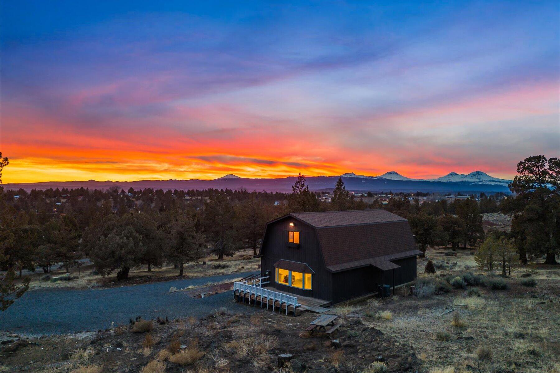 Imagine waking up every morning to breathtaking Cascade Mountain views, where fresh air and open space redefine what home feels like. Tucked just north of Bend's city limits, this 2.5-acre retreat offers a laid-back, outdoor lifestyle with plenty of room to roam. Got toys? You'll love the extra-large pole barn garage and shop—perfect for storing gear, working on projects, or launching your next adventure. Plus, with an RV pad, full hookups, and a dump station, you're always road-trip ready. Here, privacy meets possibility. Build your dream home, potentially convert the existing structure into an ADU, and create the ultimate homestead. If you're looking for space, views, and that Central Oregon lifestyle—just minutes from town—this is your place to call home. Ready to see it in person? Let's make it happen.