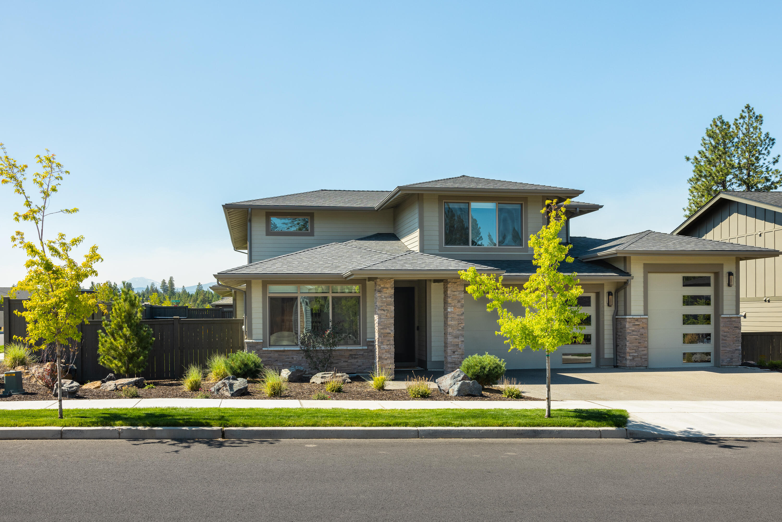 Beautiful River Vale home features Cascaded Mountain views, a warm, open floorplan with a modern kitchen with island, quartz counters, upgraded appliances, an oversized pantry, and master on the main. The downstairs master features a huge tile shower, separate soaking tub, double vanity, and walk in closet, and patio access just steps to the hot tub. If you work from home you'll love the downstairs office with separation from the other rooms to work in peace. Upstairs features an oversized media room, huge secondary bedrooms with walk-in closets and an upgraded bathroom. The spacious 3 car garage with 10' door on 3rd bay, has tons of room for all your vehicles and toys. Laundry room features a sink and cabinets for extra storage. This corner lot features a fully fenced backyard, covered patio perfect for entertaining, a well-manicured lawn, and a hot tub for relaxing.