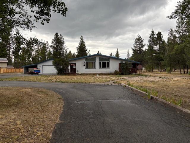 Comfortable 3 bedroom, 2 bath home located on a 1 acre parcel. Detached 2 car garage with addition added onto the back for storage as well as a carport.  2 storage buildings and a carport complete this property.  Paved Driveway.  Covered front and back decks.