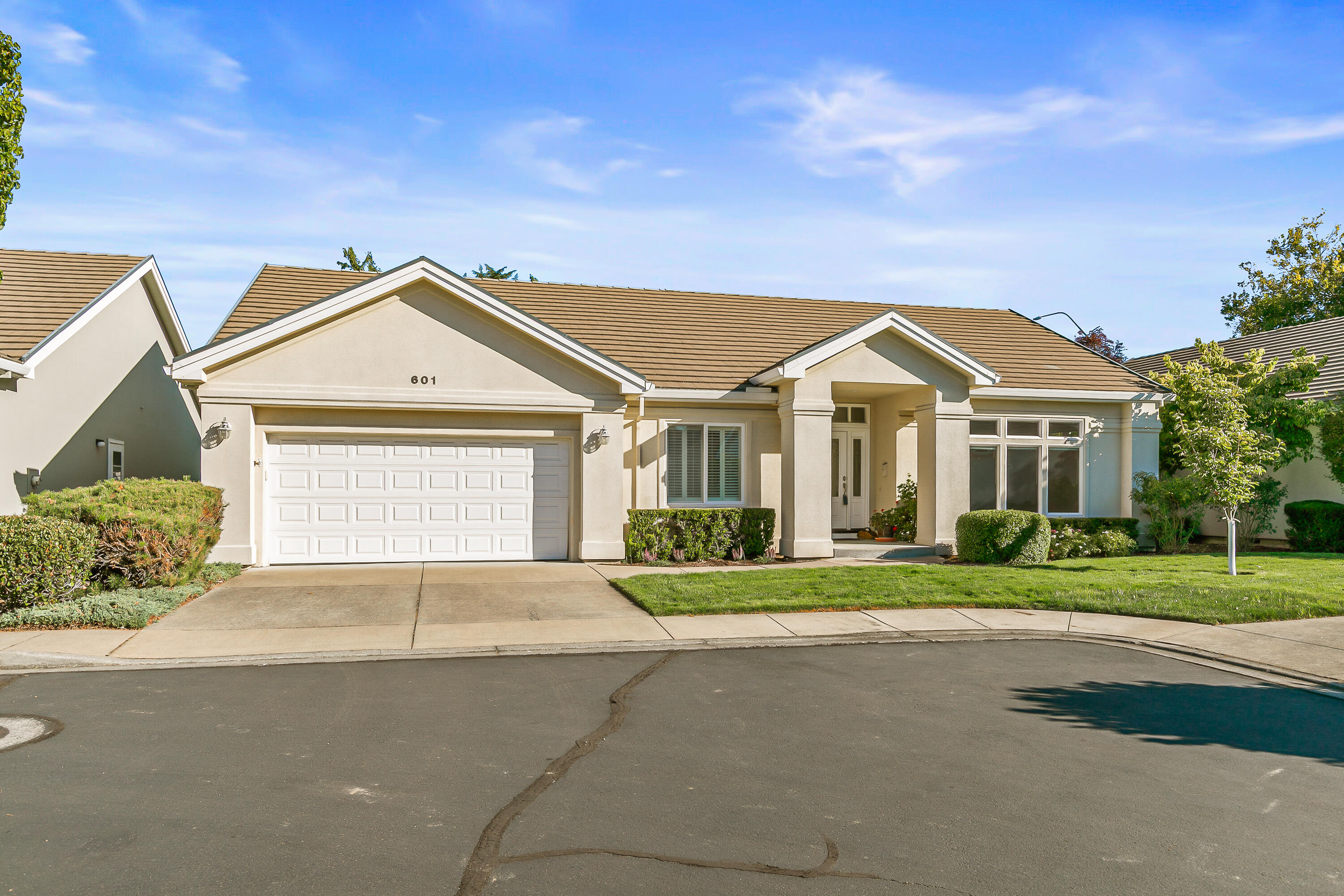 This tastefully remodeled and updated home in the prestigious Alder Creek gated community offers elegance, comfort, and thoughtful design. The heart of the home is a chef's kitchen featuring a large island, granite countertops throughout, custom cabinetry,  tile work and lighting. Soaring ceilings and hardwood floors create a warm, open feel, while the living spaces flow seamlessly for entertaining and everyday living.  Retreat to the luxurious primary suite, complete with a stunning tile shower, walk-in closet, and custom window coverings. Additional features include ample storage and carefully selected finishes that add both function and style. Enjoy the outdoors year-round on the covered patio, surrounded by beautiful, low-maintenance landscaping designed for relaxation and gatherings. Located just minutes from shopping, dining, RVCC golf course, and top medical facilities, this home offers the perfect blend of convenience and privacy.