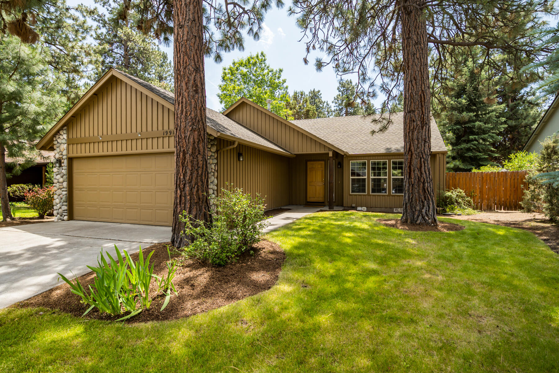 BACK ON MARKET NO FAULT OF PROPERTY! BRAND NEW ROOF INSTALLED SEPTEMBER 2025! Located on a quiet street in SW Bend's highly sought-after Quail Pine Estates, this well-maintained home offers SINGLE-LEVEL living with undeniable curb appeal. The open floor plan features vaulted ceilings, great natural light, & a cozy gas fireplace with river rock surround. The functional Kitchen has ample cabinet & counter space & flows into the Dining Area with easy access to the back patio - ideal for al fresco dining. The spacious Primary Suite includes vaulted ceilings, a walk-in closet, ensuite bath, & backyard access. Two additional bedrooms, a full Bath, & Laundry Room complete the layout. Outside: Enjoy the private, fenced backyard that overlooks natural high desert landscaping & is surrounded by mature trees.  All this just a stone's throw from the River Trail, the Old Mill, schools, parks & other Westside amenities!