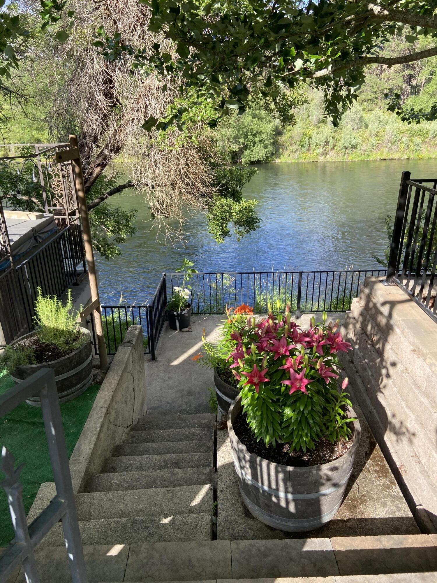 Gorgeous River Recreational River Lot on the scenic Rogue River.  Features room for two RV's  each with their own electrical panel. Approx 94 feet of River Frontage. Beautifully landscaped with multiple patios for enjoying the scenery. Steps for easy access to the River . Privacy fencings , and electrical gate with openers for easy access. Hurry this beautiful lot will not last long. Water rights, well, power , cable and internet   Double Carport and fruit trees to much to list