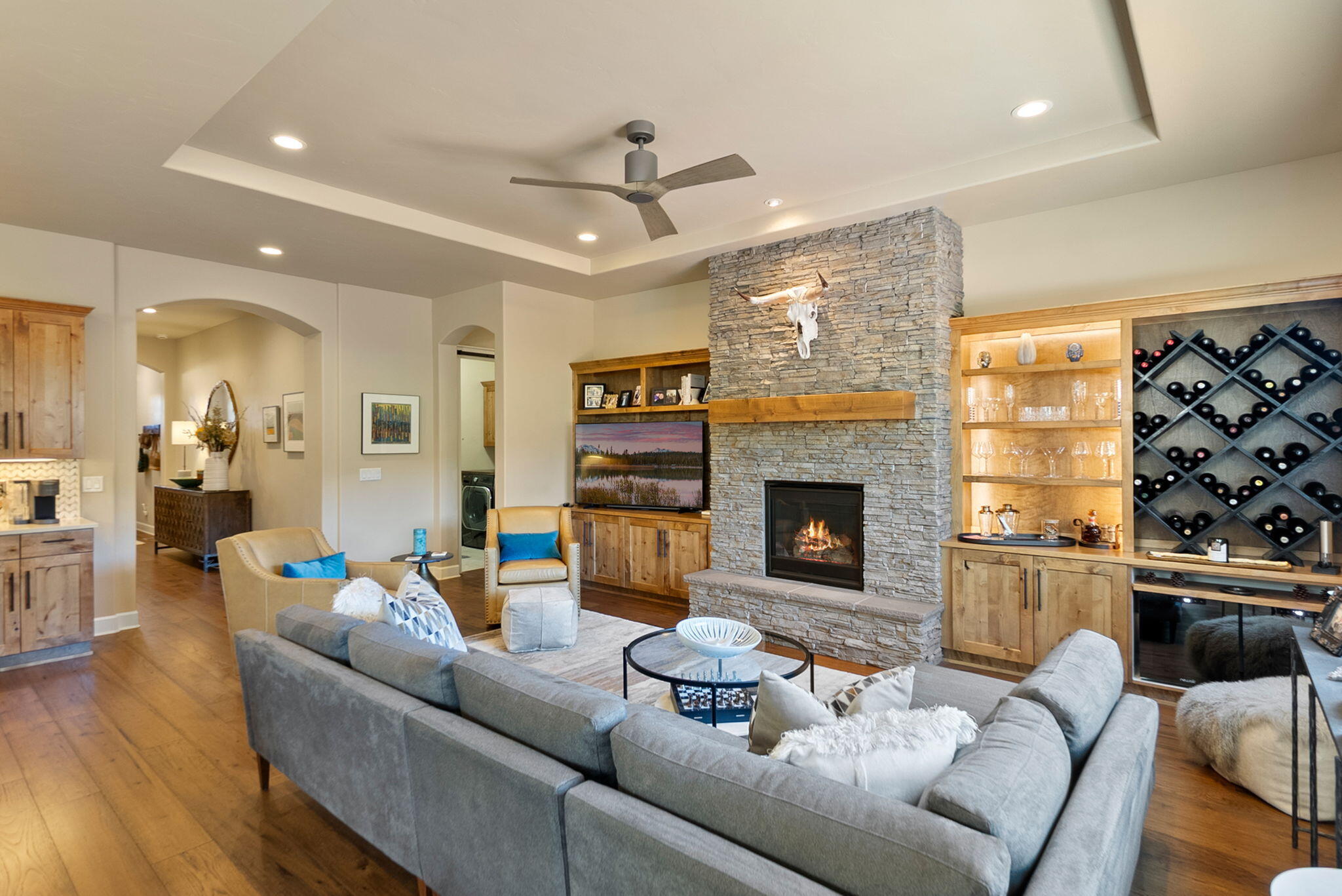 Discover this beautifully upgraded single-level home in the desirable Rivers Edge community in NW Bend. Thoughtfully designed with countless extras, this residence features soaring 10' ceilings, 8' doors, wide plank hardwood flooring, and abundant natural light. The stylish kitchen shines with a new designer backsplash, pull-out drawers in all lower cabinets, and upgraded pantry. Entertain with ease in the family room, complete with a custom dry bar and dual wine fridges. A built-in Murphy bed with cabinetry and pull-out desk adds versatility for guests or home office needs. The garage is outfitted with California Closet cabinetry for exceptional storage. Step outside to enjoy all-new landscaping, an extended paver patio, and a tranquil water feature—perfect for relaxing or gathering with friends. Every detail has been carefully considered, blending comfort, function, and style in one stunning package with a location that has river trail access and downtown in just minutes!