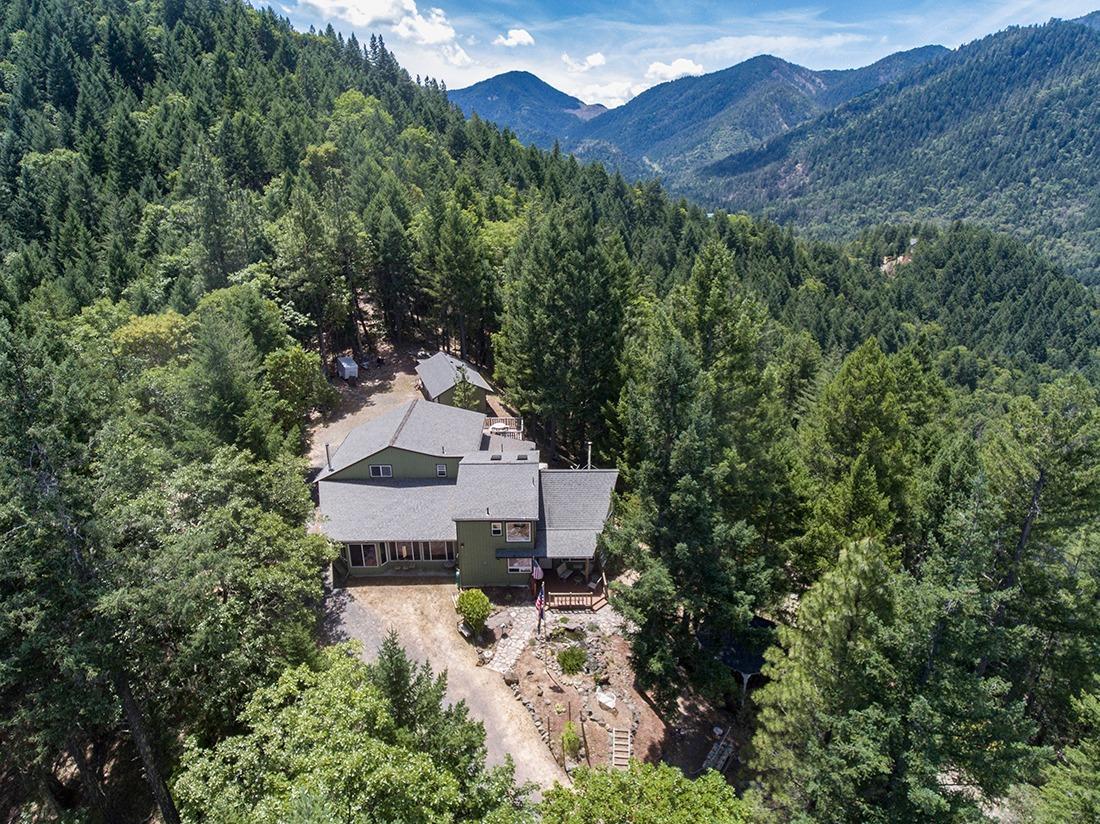 Don't let the long steep driveway and the plain exterior deter you; wait until you walk in the front door and see the interior! Wow! Beautiful tongue and groove knotty pine walls and ceiling that soar two stories with huge windows that bring in the breath taking views from the totally private 25 acre Oregon get-away. The home has 3 bedrooms and 2 baths along with the living/dining and kitchen as well as the Man Cave complete with wet bar. You'll also enjoy the large pantry. The woodworker will love the 28X30 shop connected to the attached one car garage as well as a detached 3 car garage and an additional metal shop sized outbuilding as well.