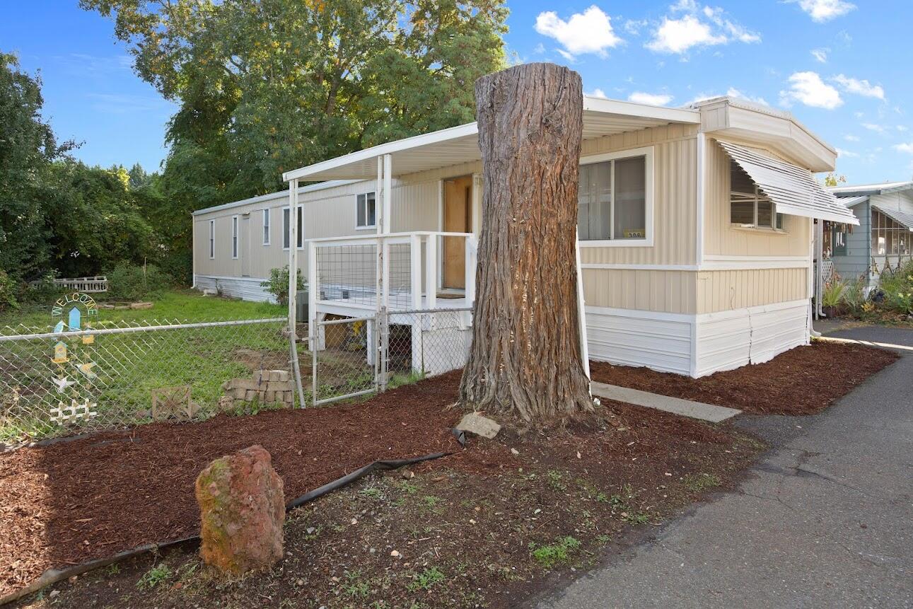 Welcome home to this beautifully remodeled 2-bedroom, 2-bath manufactured home in a peaceful 55+ park located on the scenic Rogue River. Surrounded by mature trees, this home offers a tranquil setting with brand new flooring, fresh paint, and deck—perfect for relaxing or entertaining outdoors. The spacious carport and side yard provide plenty of room for parking, gardening, or enjoying the outdoors. This pet-friendly community features wonderful amenities including a riverfront park, clubhouse with kitchen, patio and BBQ area, and convenient laundry facilities. Enjoy a low-maintenance lifestyle in a beautiful riverfront setting just minutes from town conveniences. Don't miss this opportunity to live in one of the most desirable senior communities along the Rogue River. Schedule your private tour today and experience the comfort, charm, and community that make this property truly special.
