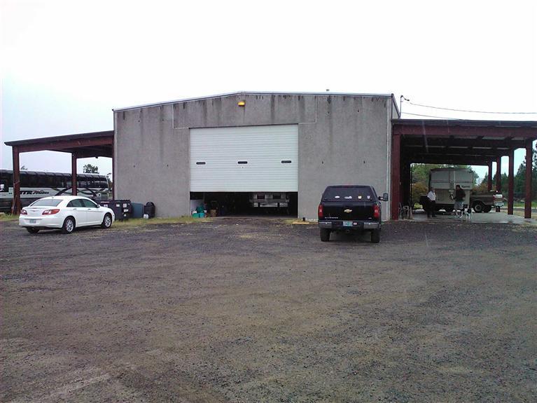 2 acre Fenced Yard! 4,000sf high ceiling industrial building with two large roll-up doors for drive through. Extra covered area along building. Gravel yard. Excellent for moving around large vehicles/trucks. Office area.