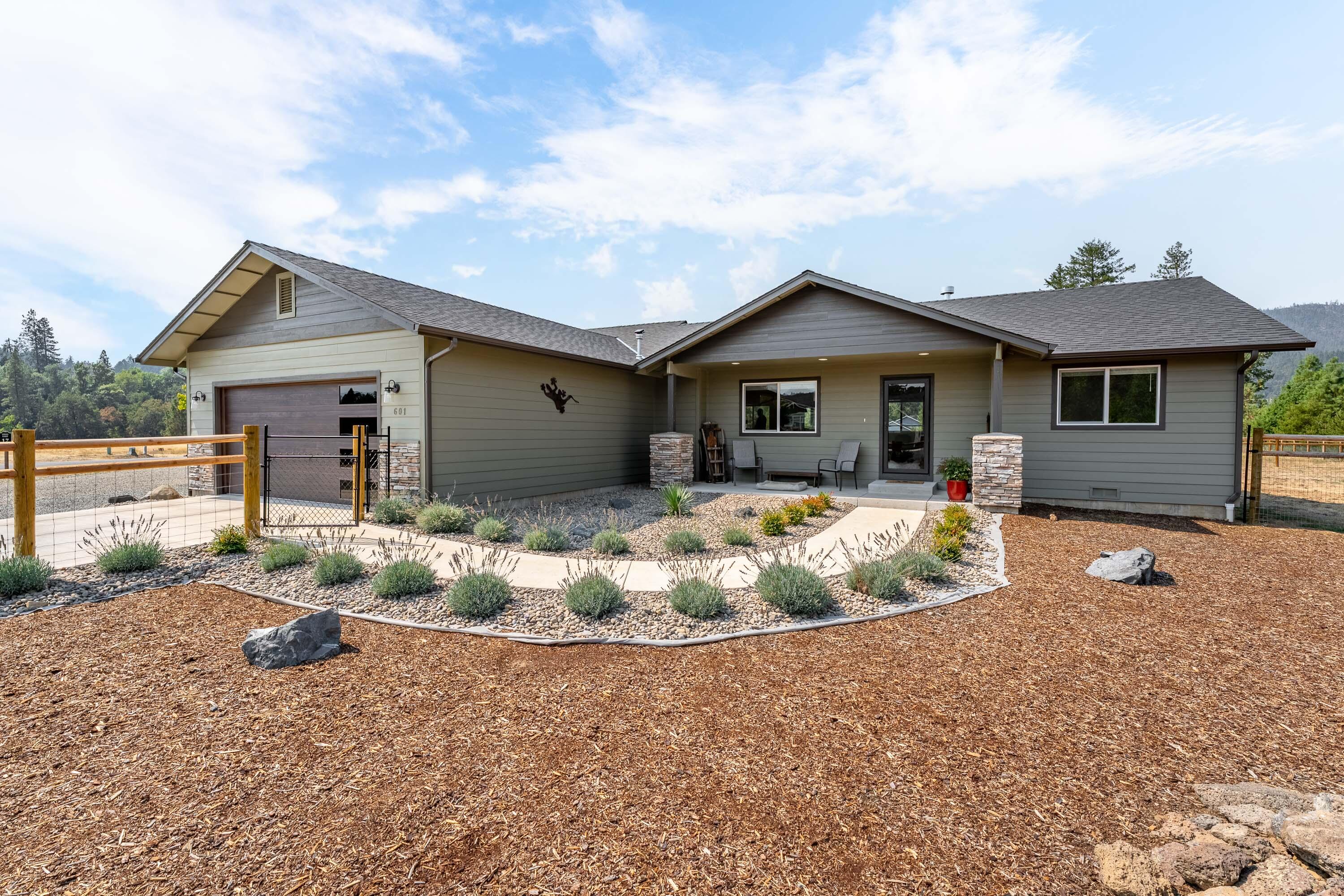 Discover this 2023-built gem tucked inside a gated community. Sellers have thoughtfully added upgrades, enhancing the already impressive design. The kitchen showcases quartz countertops, custom cabinetry, a spacious island with bar seating and a walk-in pantry. The kitchen is perfect for entertaining or preparing everyday meals with ease. The vaulted ceilings create an airy and open feel. The primary suite offers a large bathroom with double sinks and a walk-in closet. Generously sized bedrooms, a well-designed laundry room, and quality finishes throughout make this home both comfortable and elegant.
The low-maintenance yard sits on .78 of an acre, complete with a two-car garage, 12x16 storage shed, RV parking, and full fencing for privacy. Best of all, enjoy deeded access to the scenic Illinois River, making this property truly special.