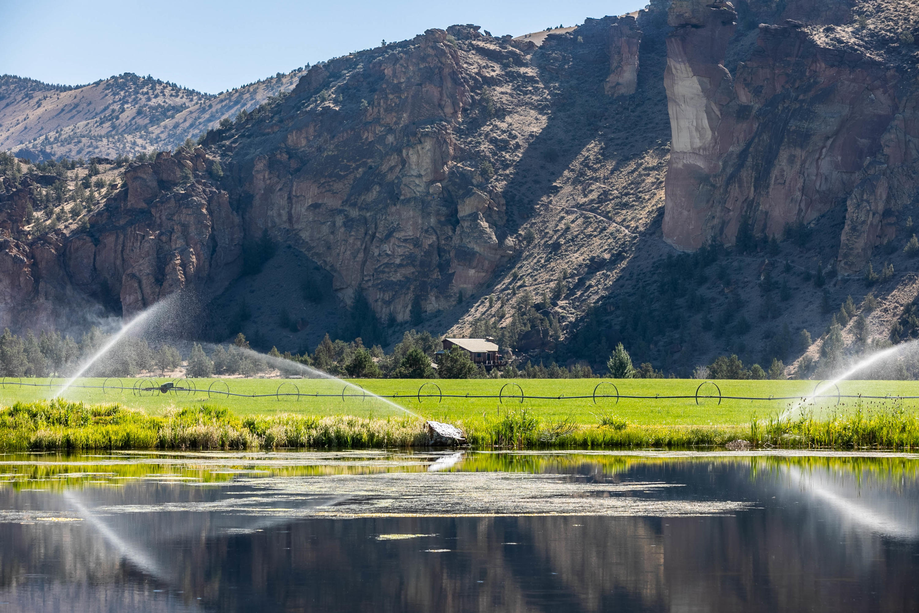 The original Headquarters at Ranch at the Canyons is magical. The sweeping spires of Smith Rock state park & the meandering Crooked River surround you. The views are jaw dropping. Witness the flights of eagles while enjoying the warmth of the sun as you gaze towards Monkey Face or turn your head to take in the full Cascade mountain views. This unique proximity to the river has been grandfathered in creating a truly special, private & peaceful space. As the gates open to the ranch the only roof top you see is the Headquarters. As you enter the Ranch and drive through the vineyard toward home the smells of juniper & sage abound.  Relax in the peaceful quiet or enjoy the outdoors. With miles of private river access for fly fishing, the community club house, stables, picnic areas and private hiking trails there is a lot to choose from. This special home is less than 20 minutes from the Redmond airport. Close to Mt. Bachelor for skiing and multiple renowned golf courses.