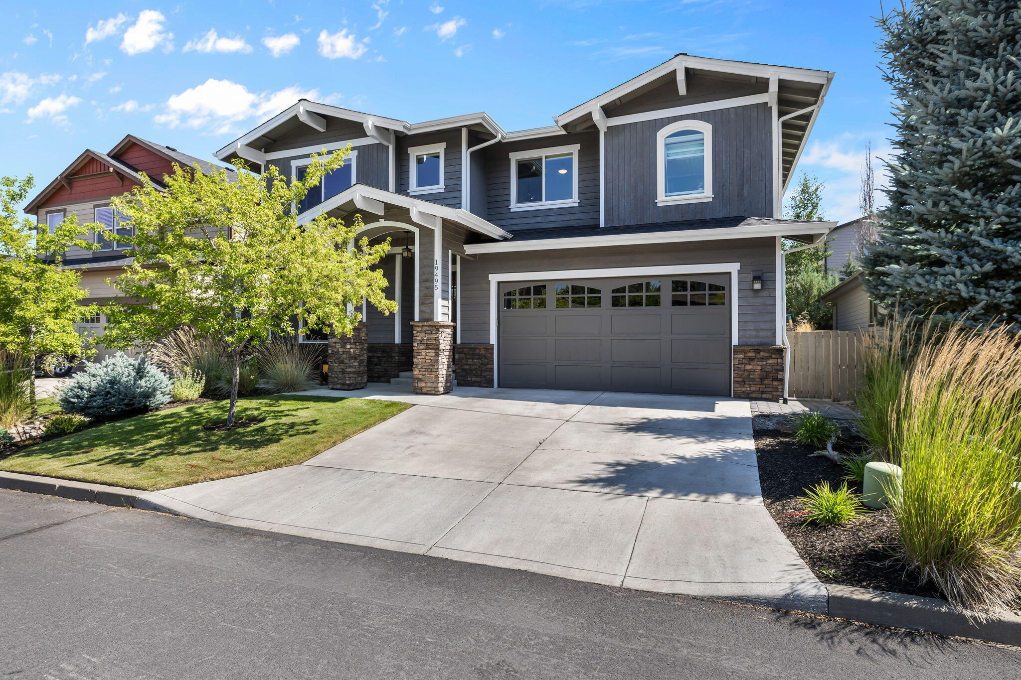 This gorgeous SW home in River Rim checks all the boxes. This 2869 sf home offers 4 bedrooms, bonus room, office AND 3 car garage. Gourmet kitchen w/quartz countertops, large island, custom built-in buffet, beverage fridge& walk-in pantry for extra storage. Open concept great room floor plan w/ custom stone fireplace & hearth. Upstairs enjoy Cascade Mountain views out your bedroom windows. Bonus room can serve as a 5th bedroom. Large primary bedroom has a shiplap fireplace w/mantle & custom board & batten headboard feature. Spacious primary bathroom boasts double vanity, floor-to-ceiling tile shower w/glass surround & soaking tub to relax in. Beautifully landscaped backyard w/extensive pavers, landscape lighting, covered patio area, fire pit, water feature & hot tub perfect for entertaining outside. Brookswood Meadow Plaza is just a stone's throw away for dining, groceries and gym. One block away -River Rim Natural Area Park w/ trails & minutes away is access to the Deschutes River.
