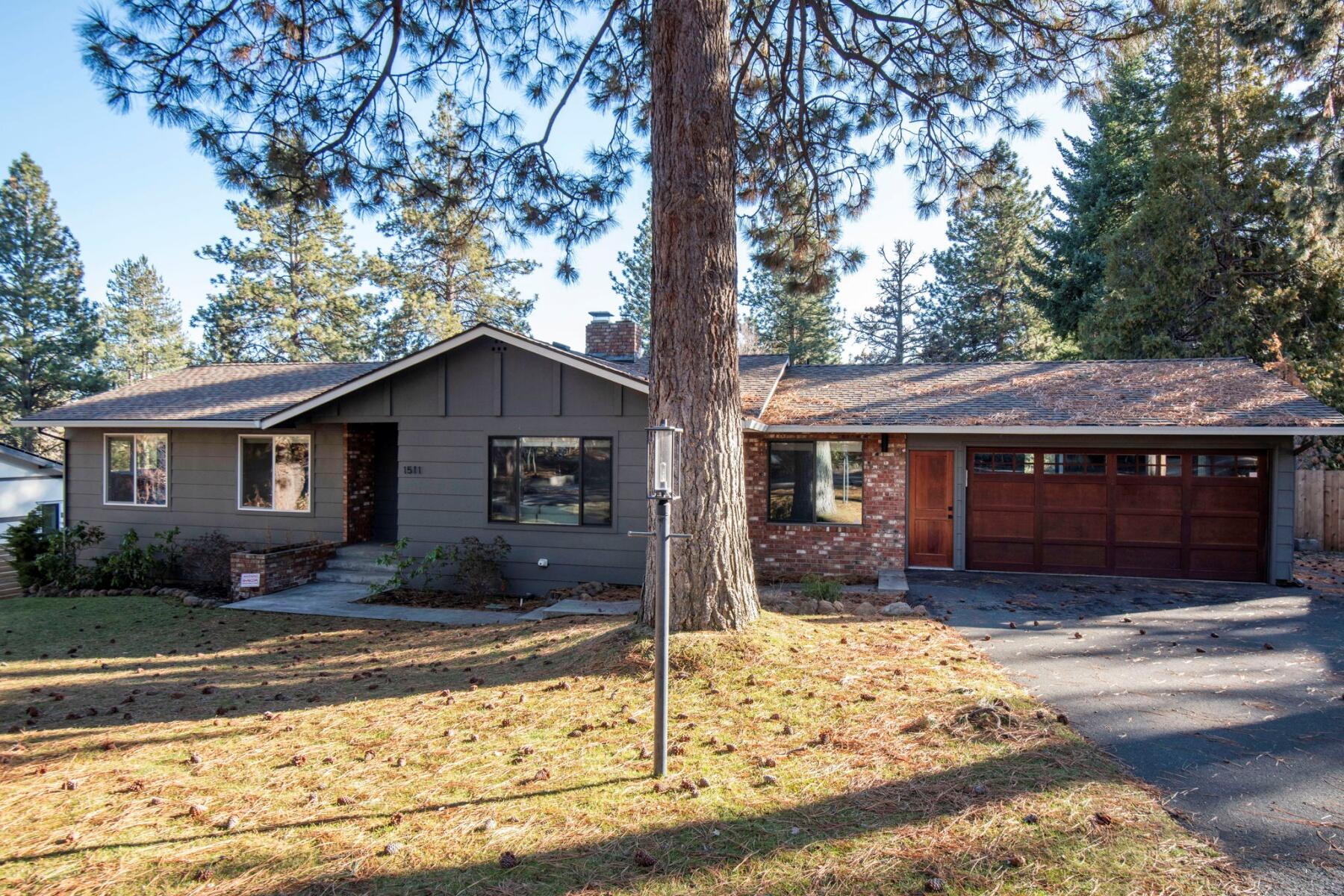 Tucked among towering Ponderosa pines, this stunning 3-bedroom, 2-bathroom home blends warmth, style, and high-end upgrades. The spacious living room shines with oak hardwood floors and a double-sided decorative fireplace. The gourmet kitchen is an entertainer's dream, featuring quartz countertops, stainless steel appliances, open shelving, and a ceiling-mounted range hood. Sliding glass doors lead to a large covered deck, perfect for morning coffee or sunset gatherings.
Need space to spread out? This home delivers with a dedicated office and a finished lower-level bonus room with a private entrance; ideal for a home office, gym, or art studio. The newly renovated bathrooms bring spa-like vibes with a walk-in shower, soaking tub, and radiant flooring. Outside, enjoy a fully fenced backyard, RV or van parking, and a spacious 2-car garage. All just minutes from downtown Bend, Newport Market, and your favorite restaurants. More than a house, this is where life happens.