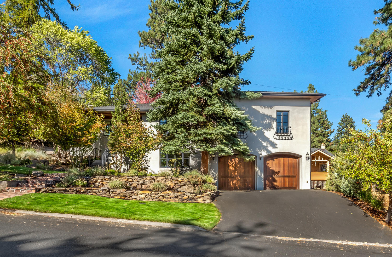 Private oasis in the heart of Bend's vibrant westside. Situated on a double corner lot, the
property feels like a private estate, while also being within walking distance of the Deschutes
River, downtown, and many of Bend's most popular amenities. The home has been seamlessly
updated to combine modern luxuries with classic, timeless finishes. The main level features an
open floor plan with a spacious master suite, built-in office, and 2 additional guest suites- each
with an en suite bath. Bathed in natural light and overlooking the backyard, the chef's kitchen is
a show stopper- complete with stone countertops, Viking appliances and butcher block island.
The expansive outdoor space is perfect for entertaining, or as a tranquil retreat and the
additional tax lot included and extra detached garage offer endless possibilities. Downstairs you
will find a family/media room with surround sound, 300+ bottle wine cellar, plus additional flex
space. Oversized 2 car garage with workshop.