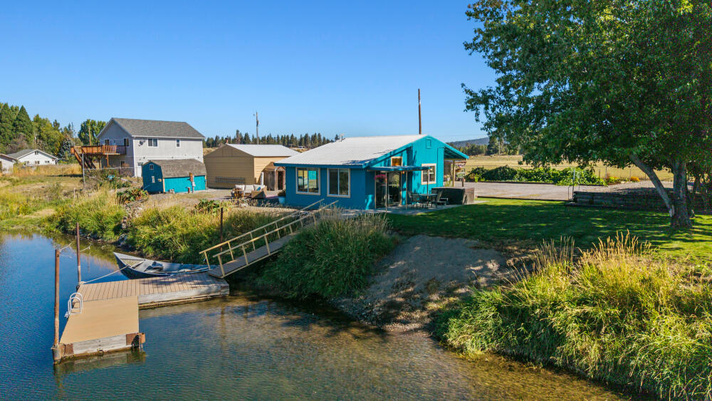 Williamson riverfront retreat; Cozy home with over 100 feet of river frontage, a private deep-water dock, and a boat ramp. From here, you can experience thousands of acres of pristine waterways, trophy trout fishing, and premier bird watching. It's truly a sportsman's paradise. The beautifully landscaped, almost half-acre lot features a large garden area with raised garden beds equipped with driplines, a 12x9 greenhouse with power and water, apple trees, mature grapes, and a grassy area with established trees and sprinklers. Inside, the home is designed to maximize the views. The open concept living area, featuring large windows, offers the ideal spot to enjoy the scenery. This well-kept, one-bed one-bath home is the perfect low-maintenance retreat. Other highlights include full RV hook-ups with water, dump, and electricity, a 20x24 open barn,  9x26 metal storage container, and a hot tub overlooking the river. Schedule a private showing today. One seller is a licensed Realtor.