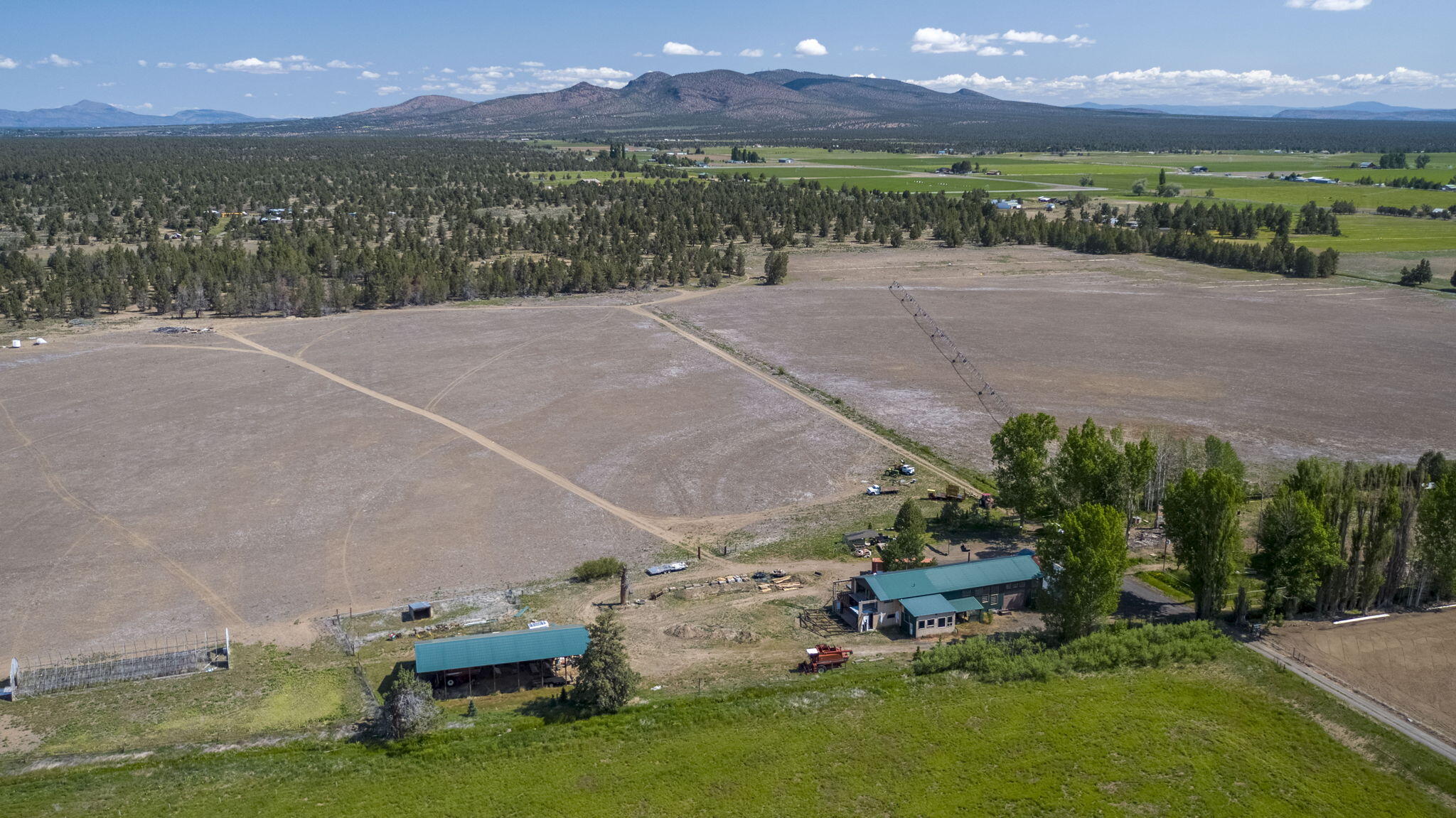 Unique farm close to the Alfalfa store in beautiful Bend Oregon that has a private and secluded feel.  Near the home site, the sound of birds and the aroma of shade tree leaves fill the air with beauty. The home was removed in 2024 and power and septic remain. Buyer to do their own due diligence for a replacement dwelling. This 200 acre farm with 81.35 irrigated acres mostly under pivot can be used for crop production or livestock grazing. The water right is a senior right through COID. There is a large shop measuring 36' by 106' and has 18' rafters. The property is comprised of 3 tax lots that are each a legal lot of record and could be purchased separately.  The barn is in great condition and can house hay and livestock. The shop has a 3000+ sqft office that is mostly framed and roughed in for plumbing and electrical. Domestic well log says 20 gallons per minute. Large mule deer bucks made the farm their home when the pivot was in production.