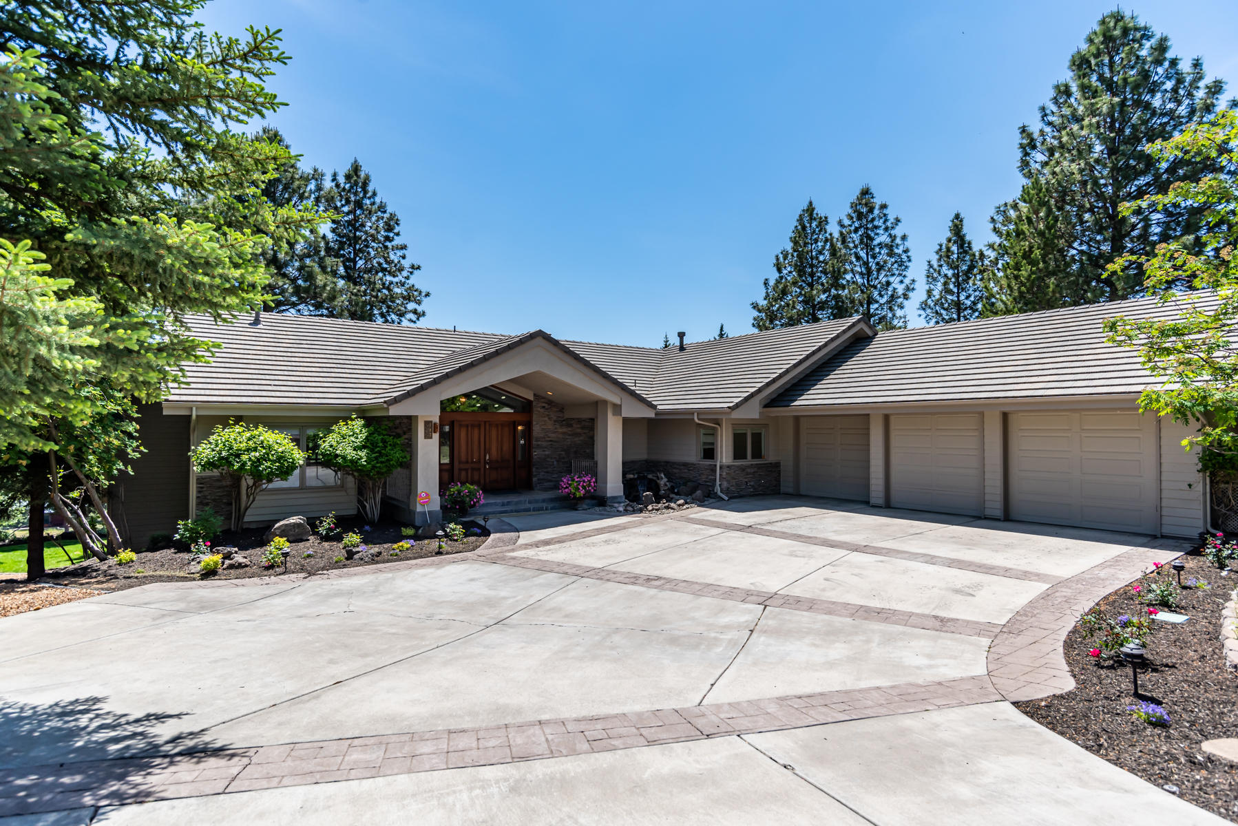 Enjoy striking views of the calm Deschutes River and iconic Old Mill smoke stacks in the distance from this custom home on Bend's coveted NW side. Spacious driveway with triple car garage, easy care landscaping & soothing water feature just outside the welcoming entrance. Main level living features large vaulted ceilings, spacious living room, great room, 2nd bed, full bath & main level master with private access to large deck overlooking the river. Kitchen has just been update with new stainless appliances plus new paint throughout most of the interior. Downstairs offers an additional master suite, office/work shop & another full kitchen making this a great home for multi-generational families. Retire out to a second rear patio plus ability to create access down the river and trials. All this just minutes from fine dining, great shopping & award winning River's Edge Golf course.