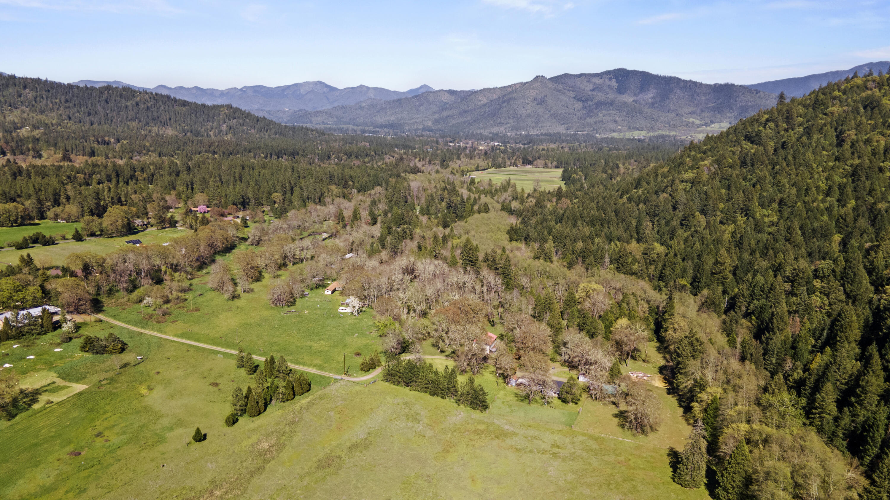 Welcome to this private, gated oasis situated on 41.76 acres (three combined parcels) in beautiful Williams, OR! Come enjoy wildlife right out your front door! 3 bed/2 bath w/ new roof and fresh interior and exterior paint. Multiple heat sources - wood burning stove, forced air/heat pump, & oil heating stove. Excellent well water pressure! Breathtaking views of the valley, mountains, and Williams Creek which runs through the property year-round, plus a spring-fed pond. Water rights with irrigation infrastructure in place provides incredible agricultural opportunities! Mature timber located on the backside of the property provides income potential with standing timber estimated at $175k. Fenced-in garden area with 8' fence. Property is also fenced and includes various outbuildings: 40 x 70 barn w/ spacious storage loft, chicken coop, wood shed w/ storage, pump shed & an add'l storage shed. RV parking and electrical hookup by creek. High speed fiber optics being installed down driveway.
