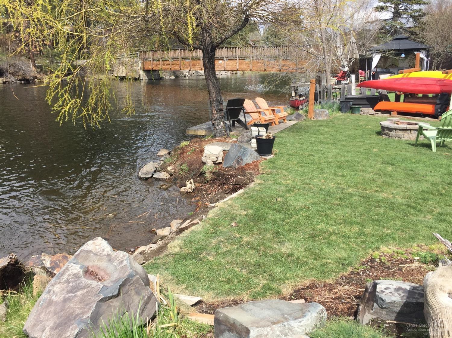 Rare opportunity to purchase one of the best downtown river front lots in Bend. Right between Miller Landing Park and Columbia Park. Approved Vacation Rental Land Use Permit in place, transferable. Approved dock. Built in 1918, the house is in varying degrees of remodel and updating. House is being sold as-is Buyer to do own due diligence.