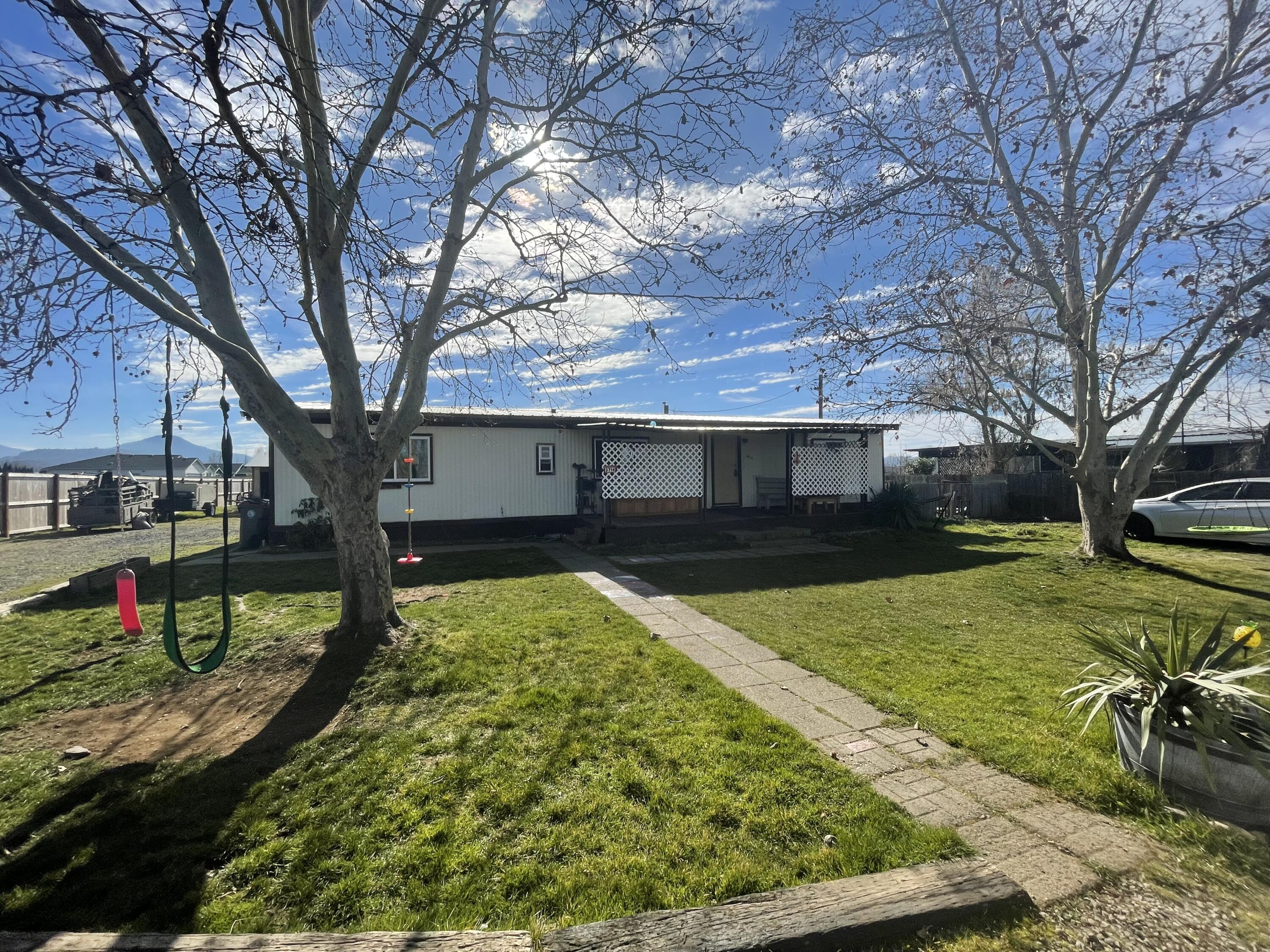 Fantastic investment opportunity! Hard to find 1 acre on city services, with a well, as well as city water, zoned WCUR-6. Right next to Woodland subdivision, utilities
already there with a 3 bedroom, 2 bath, 1344 square foot home. Nice floor plan, with a covered patio out back. The land goes beyond the fence out back with fantastic views of Mt Mcglaughlin. Great location, with easy access to Foothill, or Hwy 62. Within an hour of several lakes, the Rogue River, Waterfalls, and hiking trails. 24 hour notice
required for all showings, appointment only!