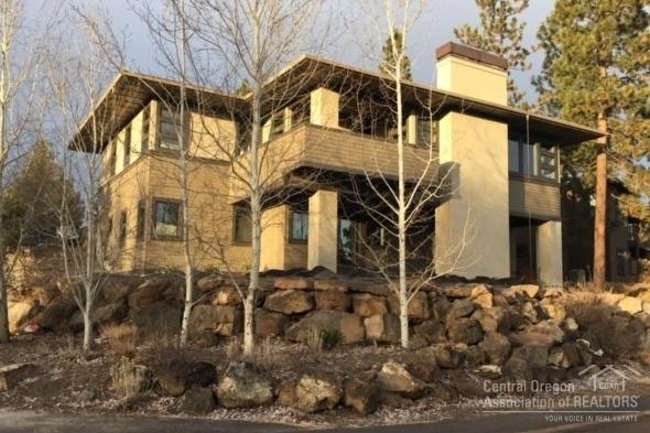 Located in desirable Three Pines, this extraordinary Prairie-style home is poised on a spacious corner lot overlooking treed open space, only steps to a neighborhood park and the paved walking/biking trail to Bend's 650/ac Shevlin Park. Experience a wonderful home that feels NEW, as it won't disappoint the most discriminating buyer. Featuring spacious main level living, a chef's dream kitchen, three bedrooms all w/private bathrooms & walk-in closets, an expansive, multi-use family room downstairs (shown as a huge library)...all in a light-filled, modernist interior space showcasing an array of beautiful features and appointments.