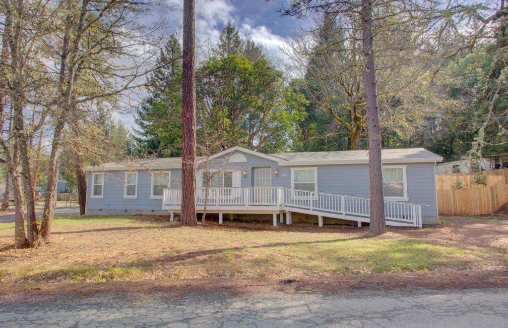Great location! Set down a country road with quick access to 199 Hwy, this property is close to downtown Cave Junction, the Illinois River and a short trip to Grants Pass or the Coast. Built in 2003 with 1832 square feet this home consists of 4 bedrooms 2 full bathrooms. Contemporary in style with an open floor plan, vaulted ceilings this home is equipped with handicapped accessible ramp that leads up to your front porch with trex decking great for entertaining. Through the front door is a spacious front entry/living room, open kitchen with Island, pantry, generous separate fridge & freezer units, formal dining room, split floor plan that offers a Master Bedroom with ensuite that complete with a jetted tub, shower, and 3 bedrooms with a second full bathroom on the other side. Off the kitchen is your laundry room that leads to a back deck overlooking a fenced backyard. Great layout, location and close to City Services. Comfortable country living at an affordable price!