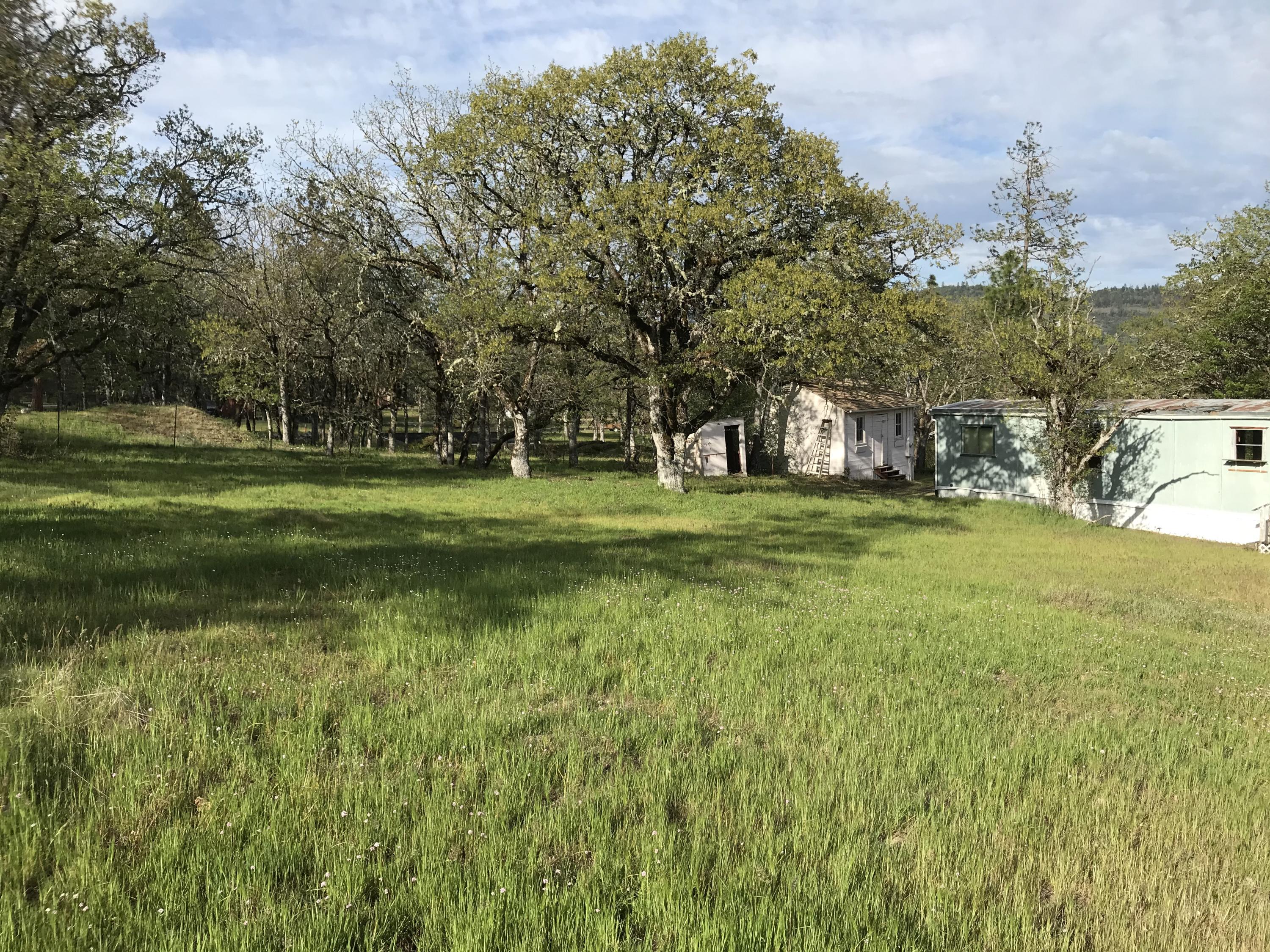 Beautiful property for a new home. Live in old manufactured home and build or put a new manufactured on property. Great well. Wonderful views of the surrounding hills and valleys. Close to recreation for fishing, boating of all types, floating the river, camping and more. Manufactured home is of little value, but livable. There are two nice storage buildings and property is partially fenced for animals.